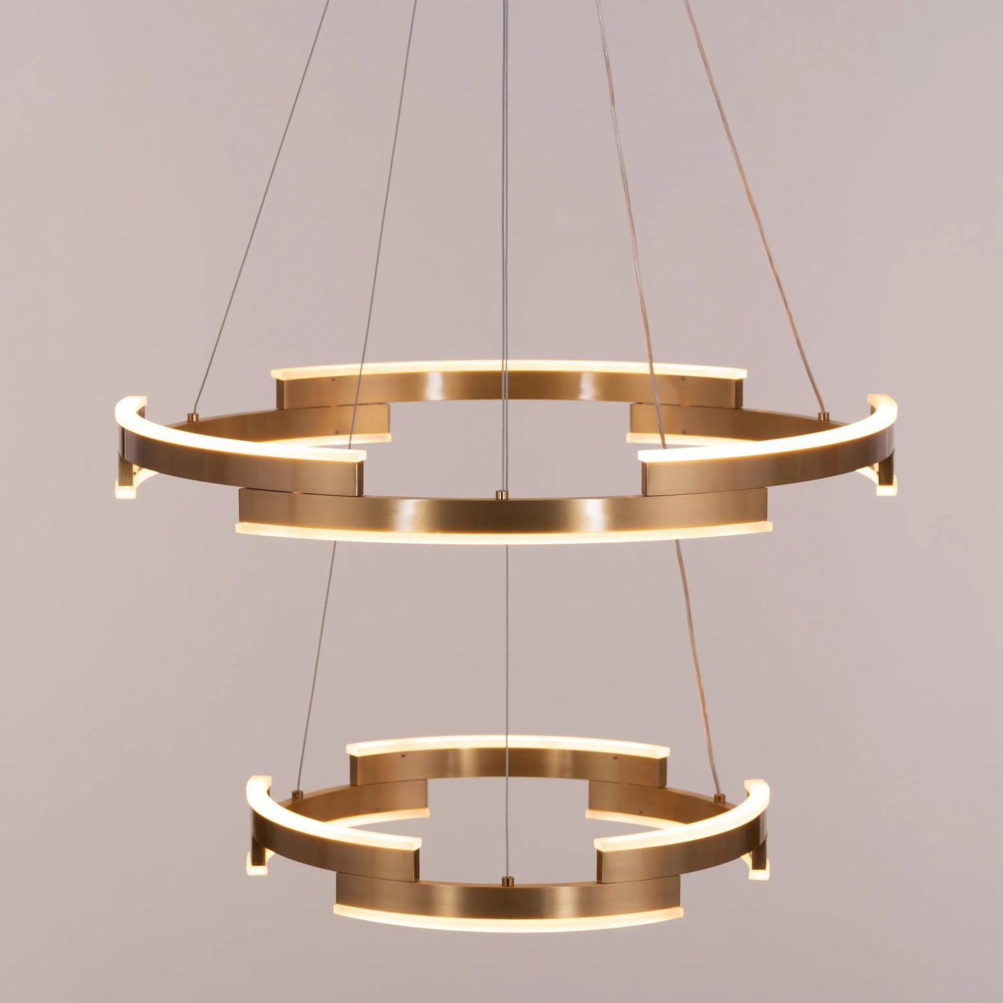 Bring A Friend medium gold chandelier with dimmable LED lights illuminating a modern dining room
