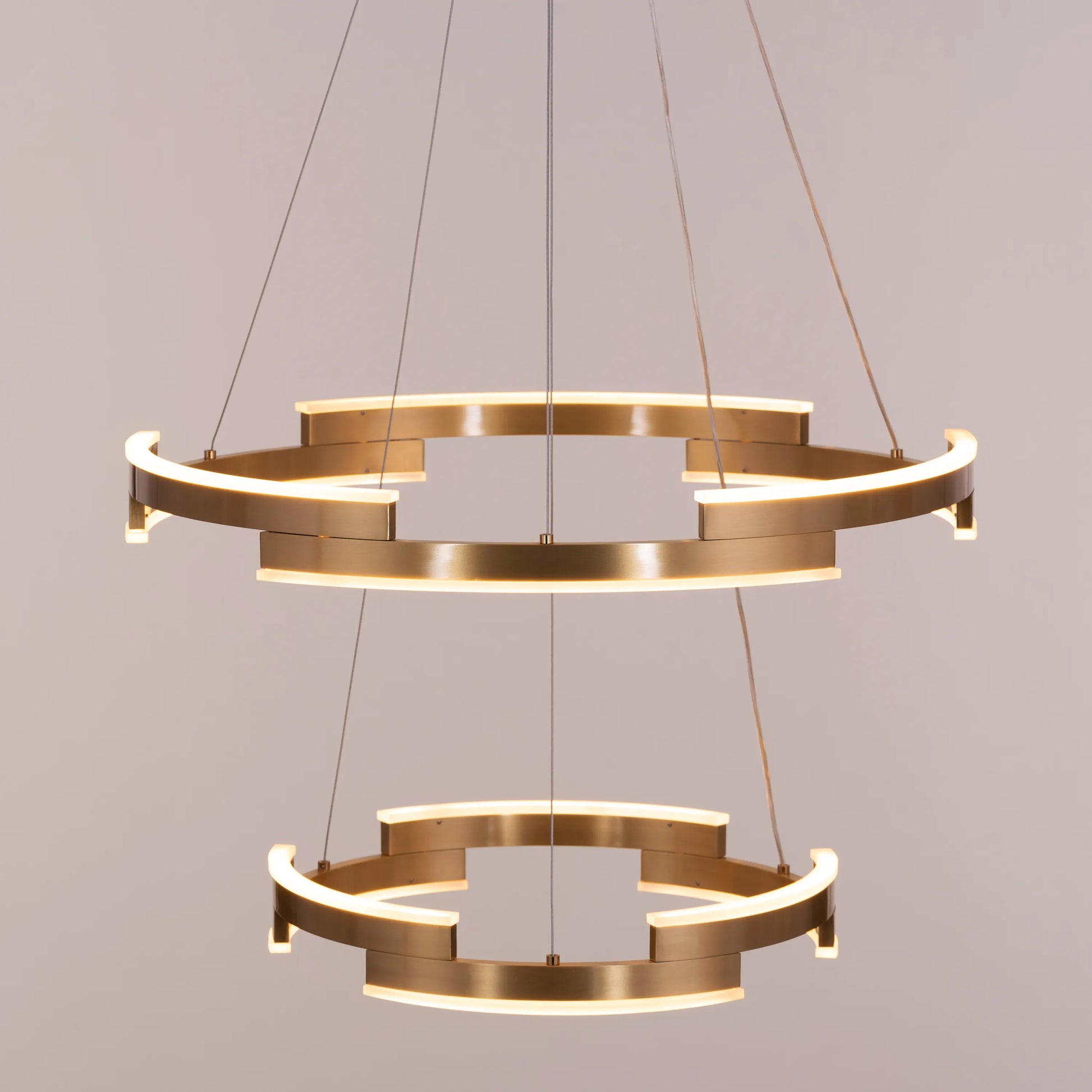 Bring A Friend medium gold chandelier with dimmable LED lights illuminating a modern dining room