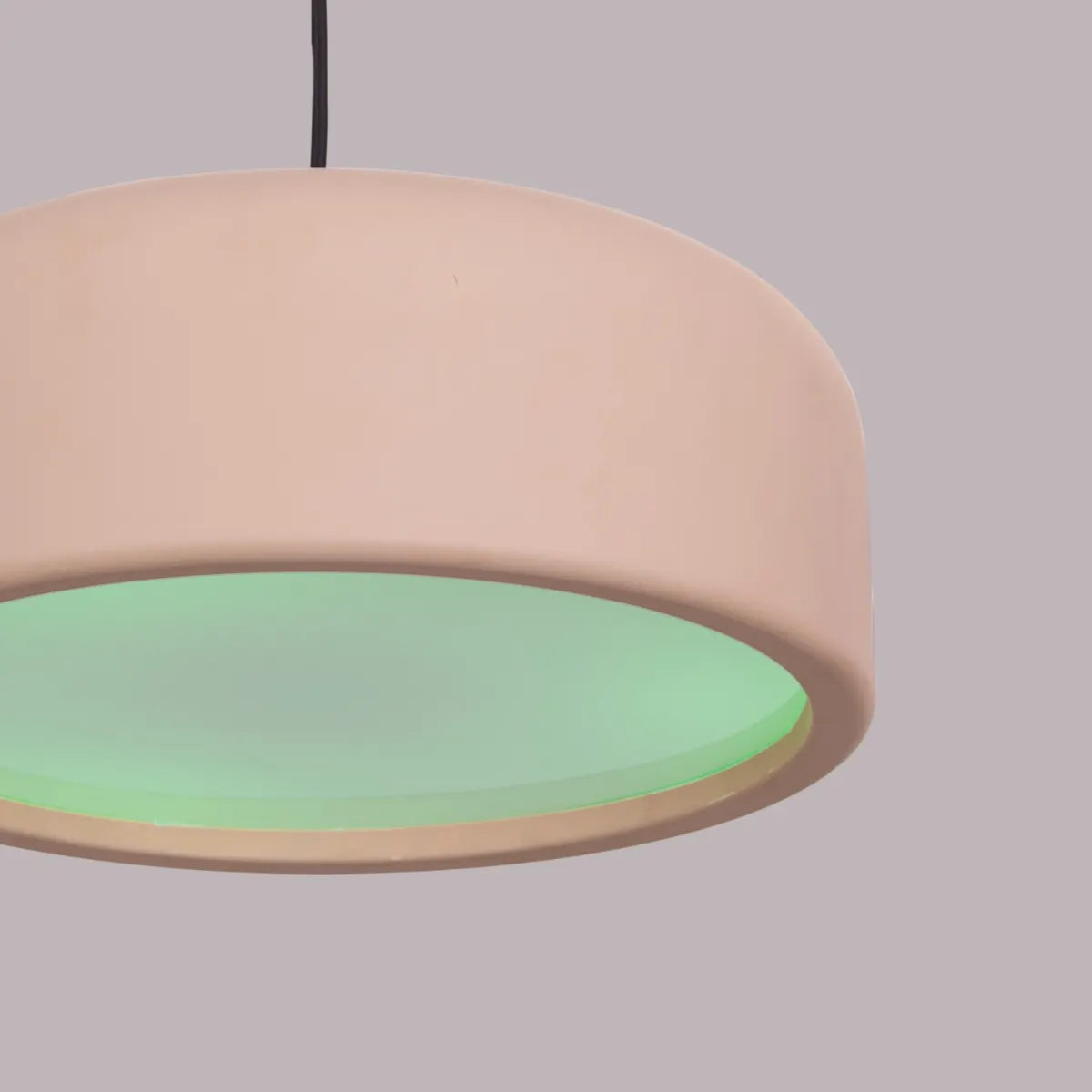 An artistic pendant light with a sleek, abstract design. It features a brushed brass metal frame, suspended by thin cables, with soft, warm light emitted through frosted glass diffusers. The light creates a modern, elegant ambiance, perfect for contemporary interiors.