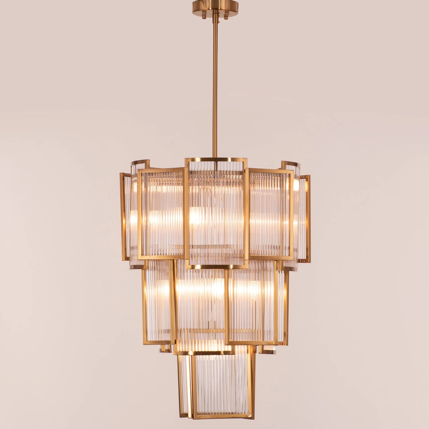 Melrose Place gold chandelier with tiered crystal drops illuminating a luxurious dining room