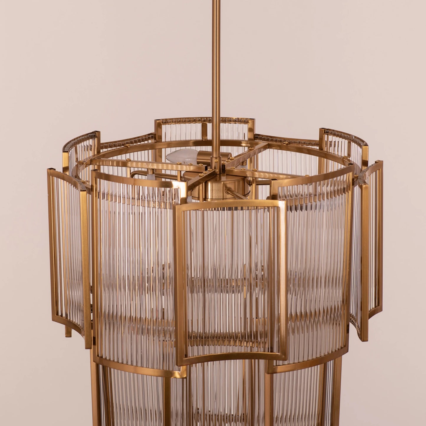 Melrose Place gold chandelier with tiered crystal drops illuminating a luxurious dining room