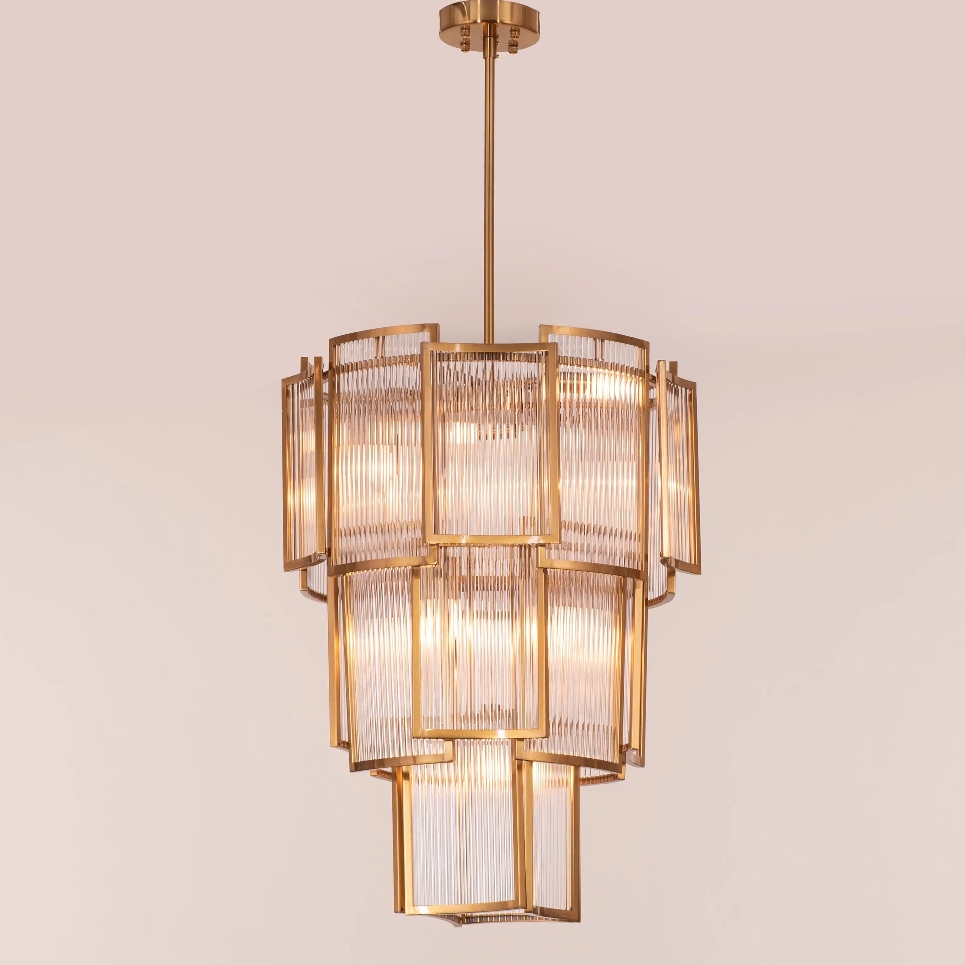 Melrose Place gold chandelier with tiered crystal drops illuminating a luxurious dining room