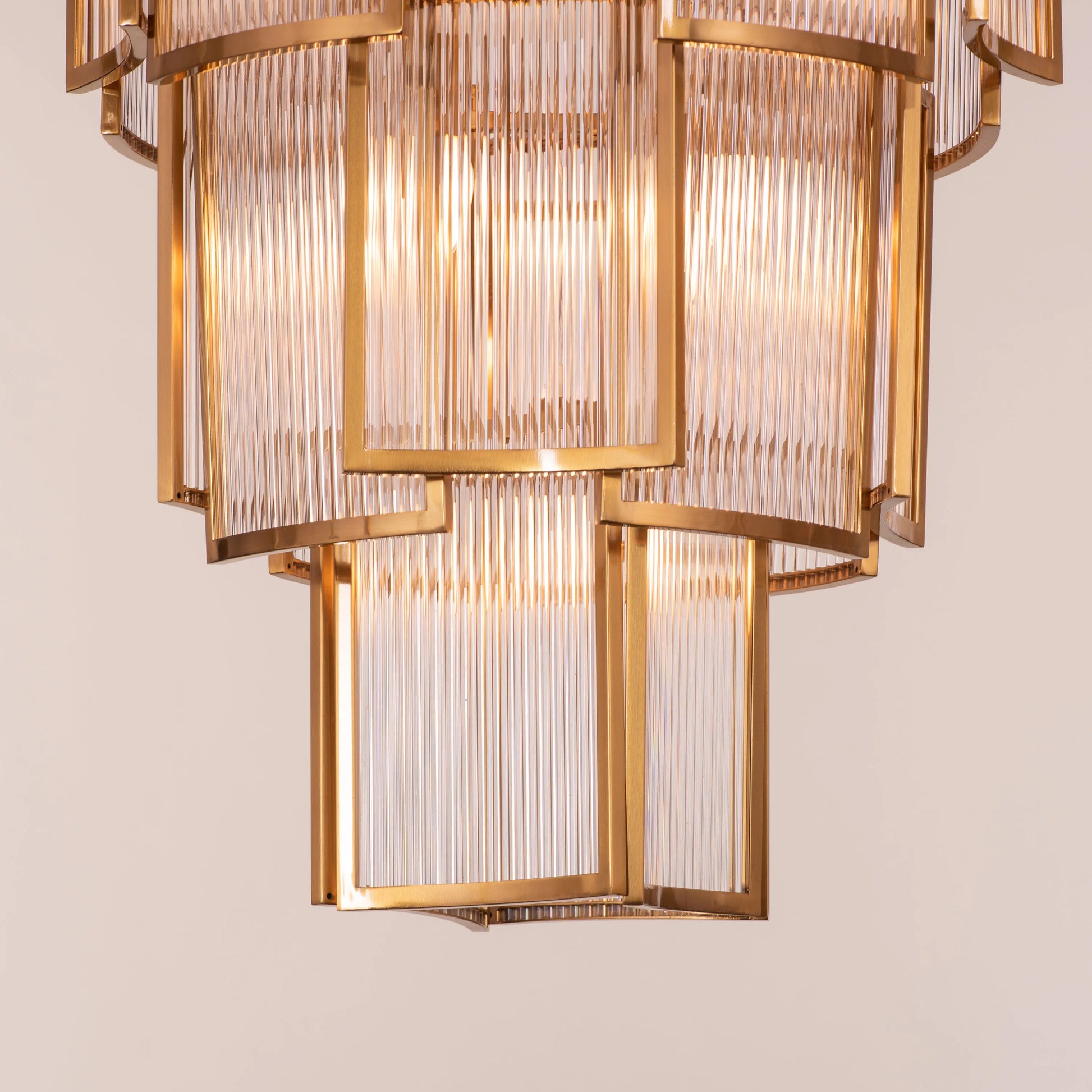 Melrose Place gold chandelier with tiered crystal drops illuminating a luxurious dining room