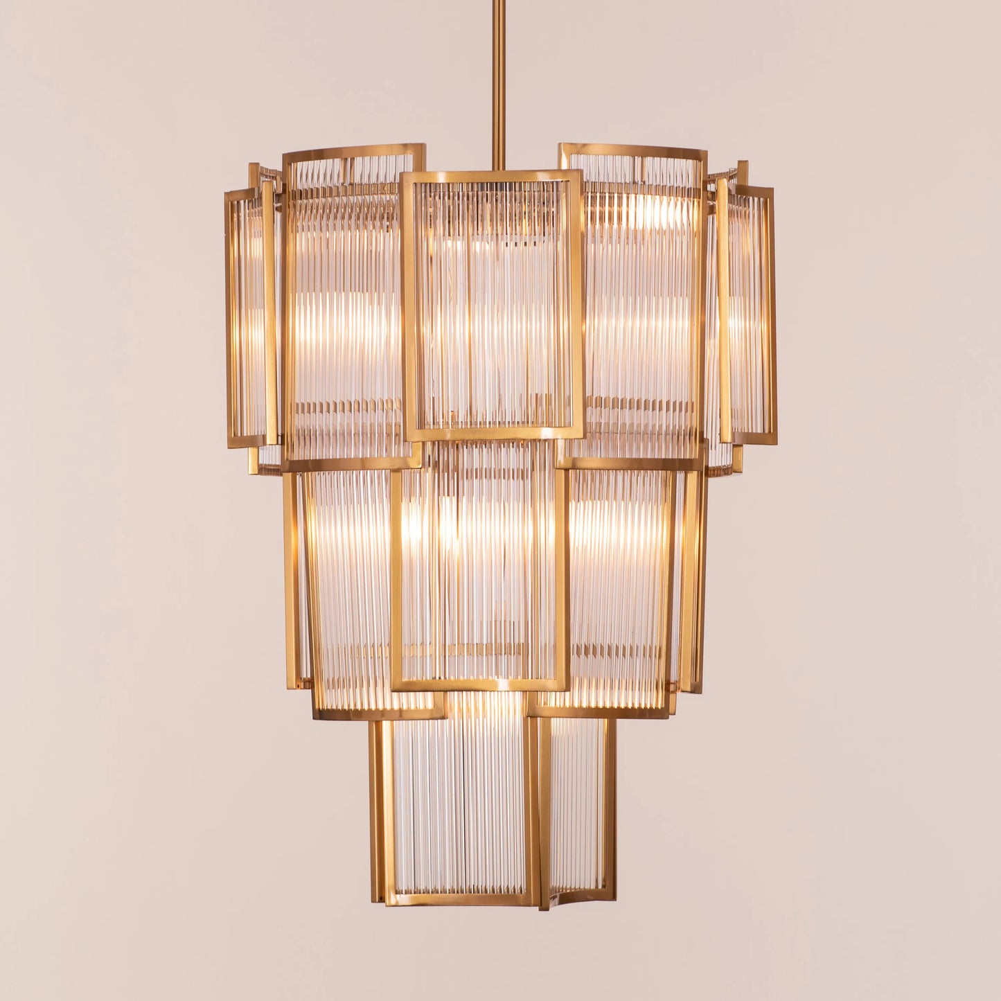 Melrose Place gold chandelier with tiered crystal drops illuminating a luxurious dining room