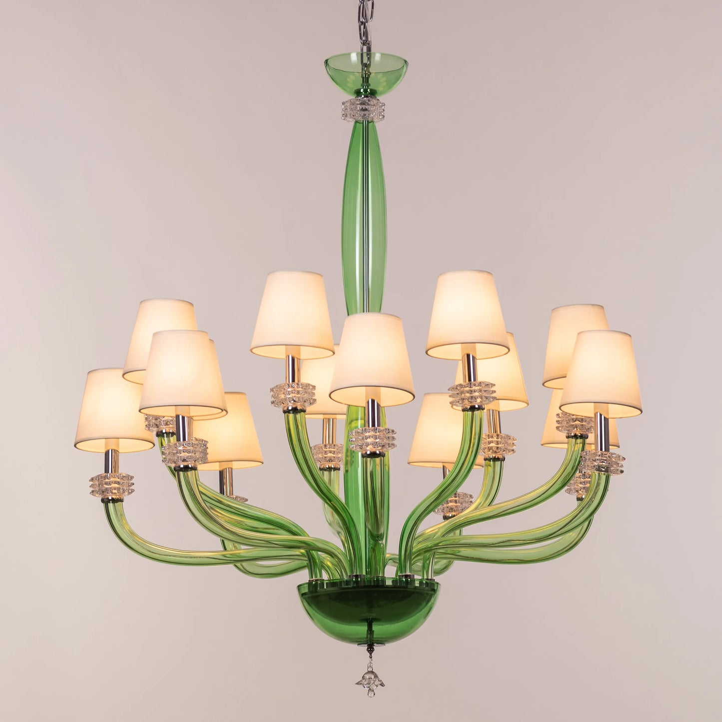 Large green and white glass chandelier with cloud-like forms and warm lighting