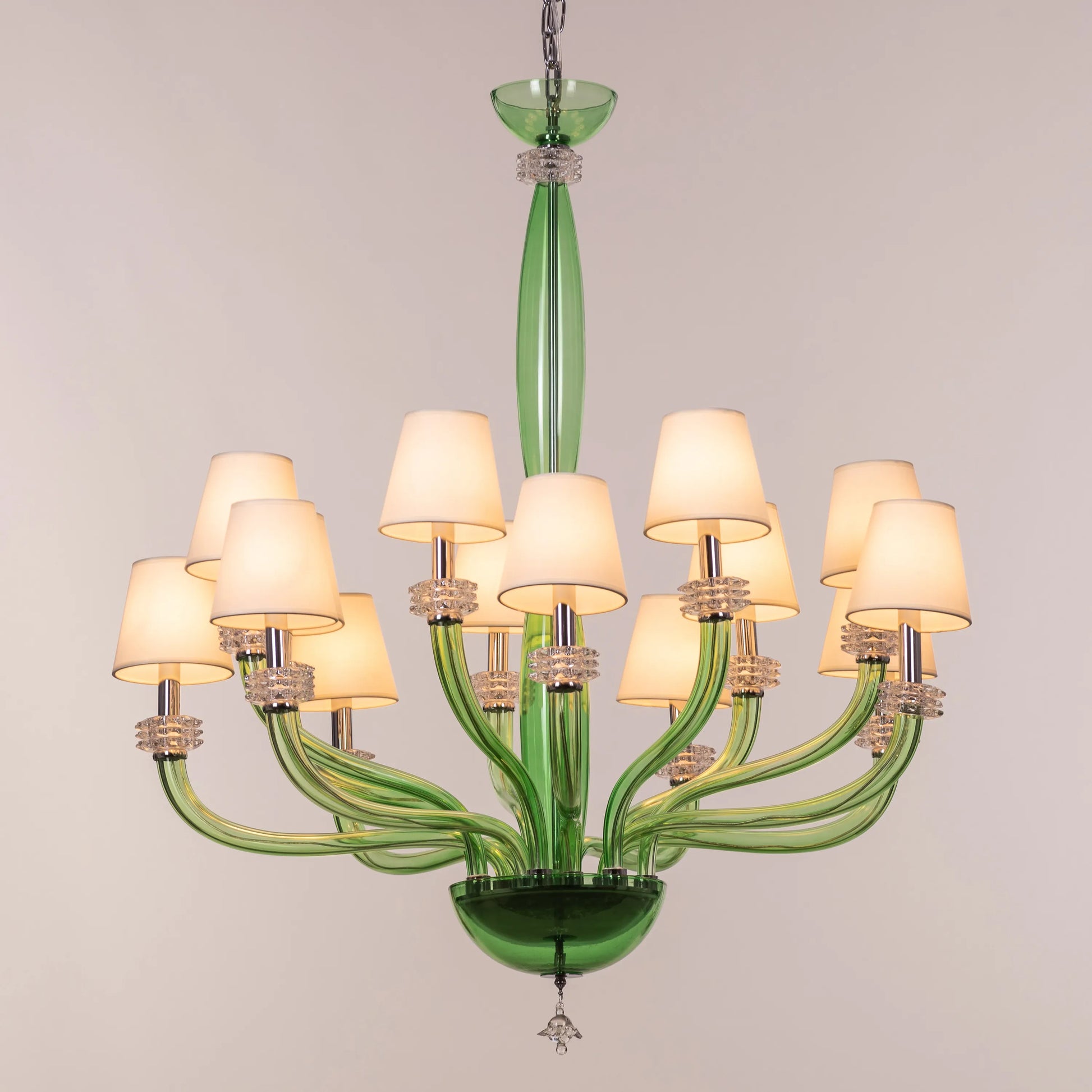 Large green and white glass chandelier with cloud-like forms and warm lighting