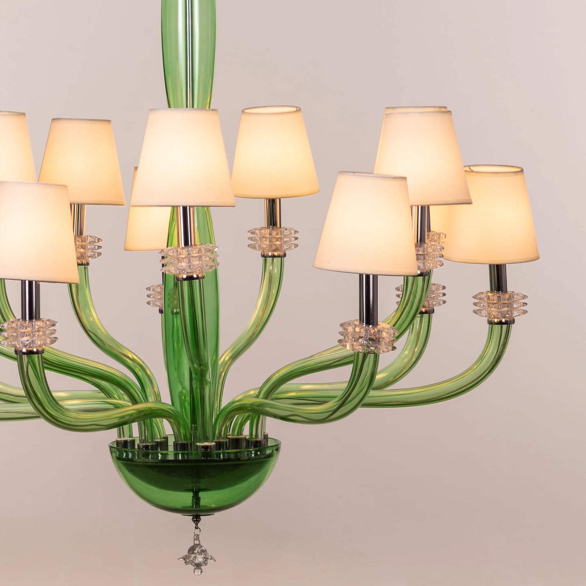 Large green and white glass chandelier with cloud-like forms and warm lighting