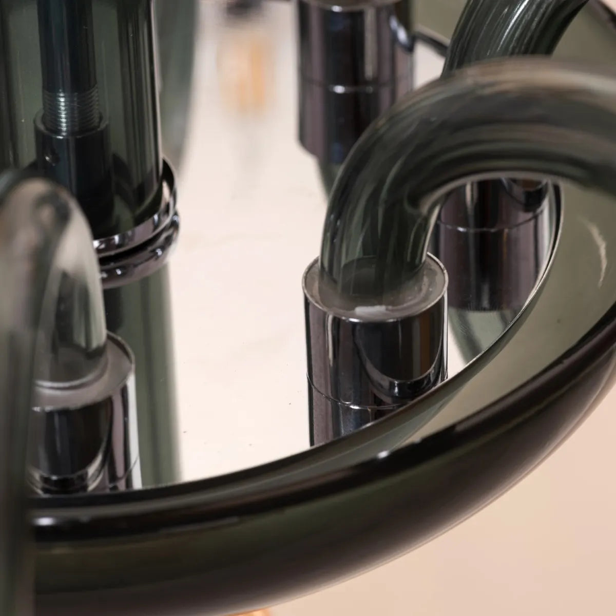 Large "Steps Of Rome" chandelier with tiered green and amber glass elements, dramatically illuminated in a spacious, elegant room.