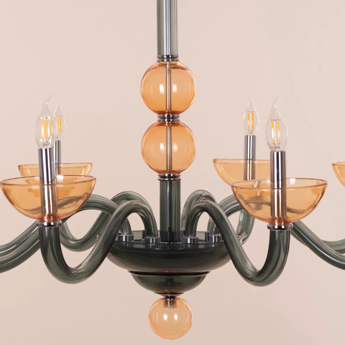 Large "Steps Of Rome" chandelier with tiered green and amber glass elements, dramatically illuminated in a spacious, elegant room.