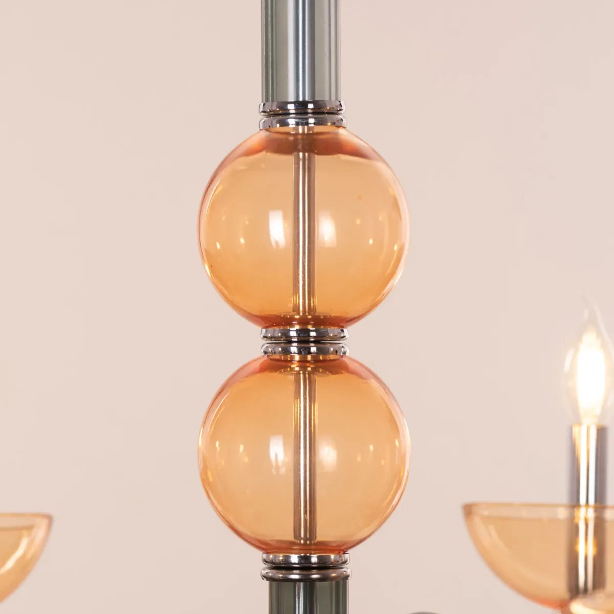 Large "Steps Of Rome" chandelier with tiered green and amber glass elements, dramatically illuminated in a spacious, elegant room.