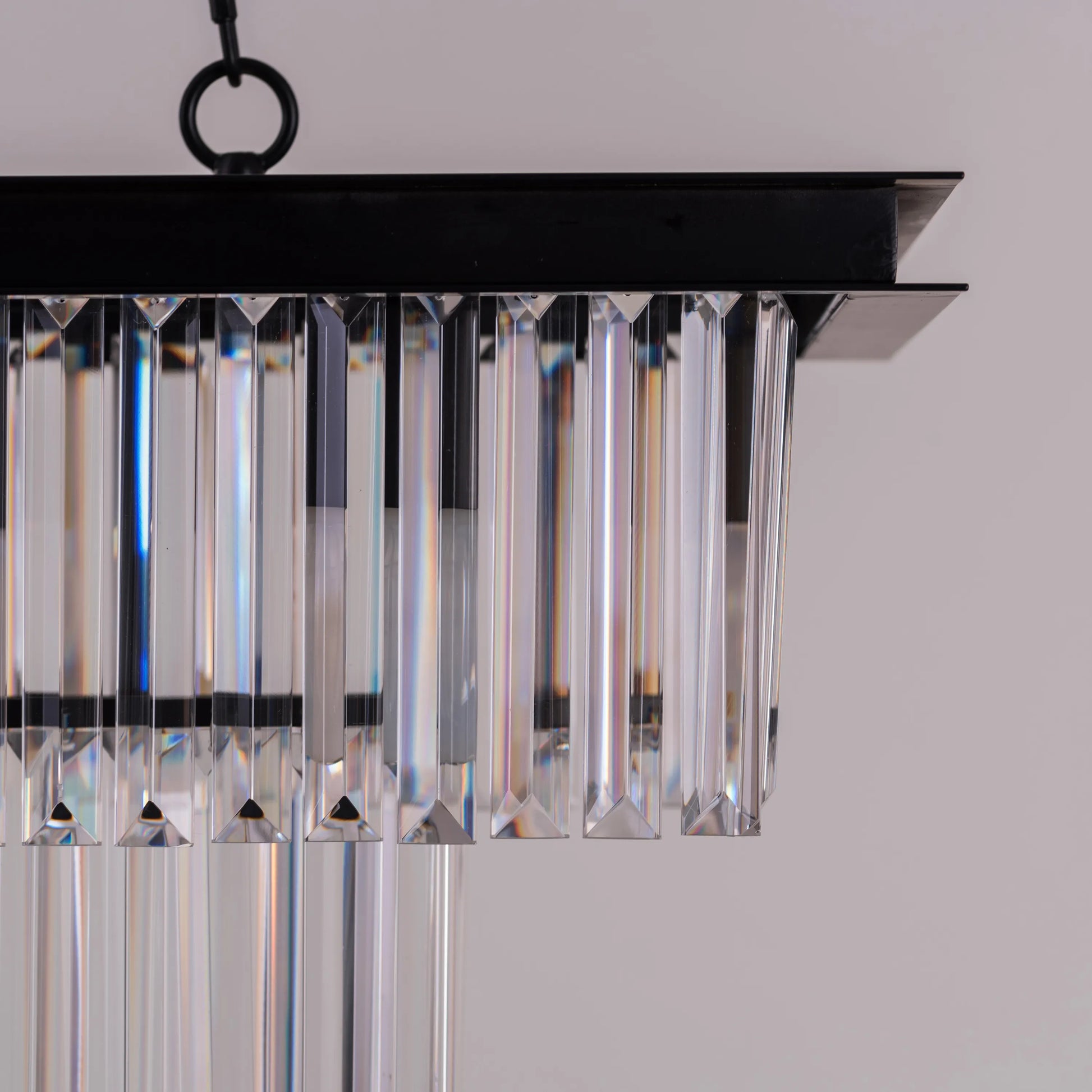 Trust Fund Baby crystal chandelier hanging in a luxurious grand foyer.