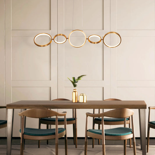 Large gold How We Play chandelier with playful design elements illuminating a luxurious living room