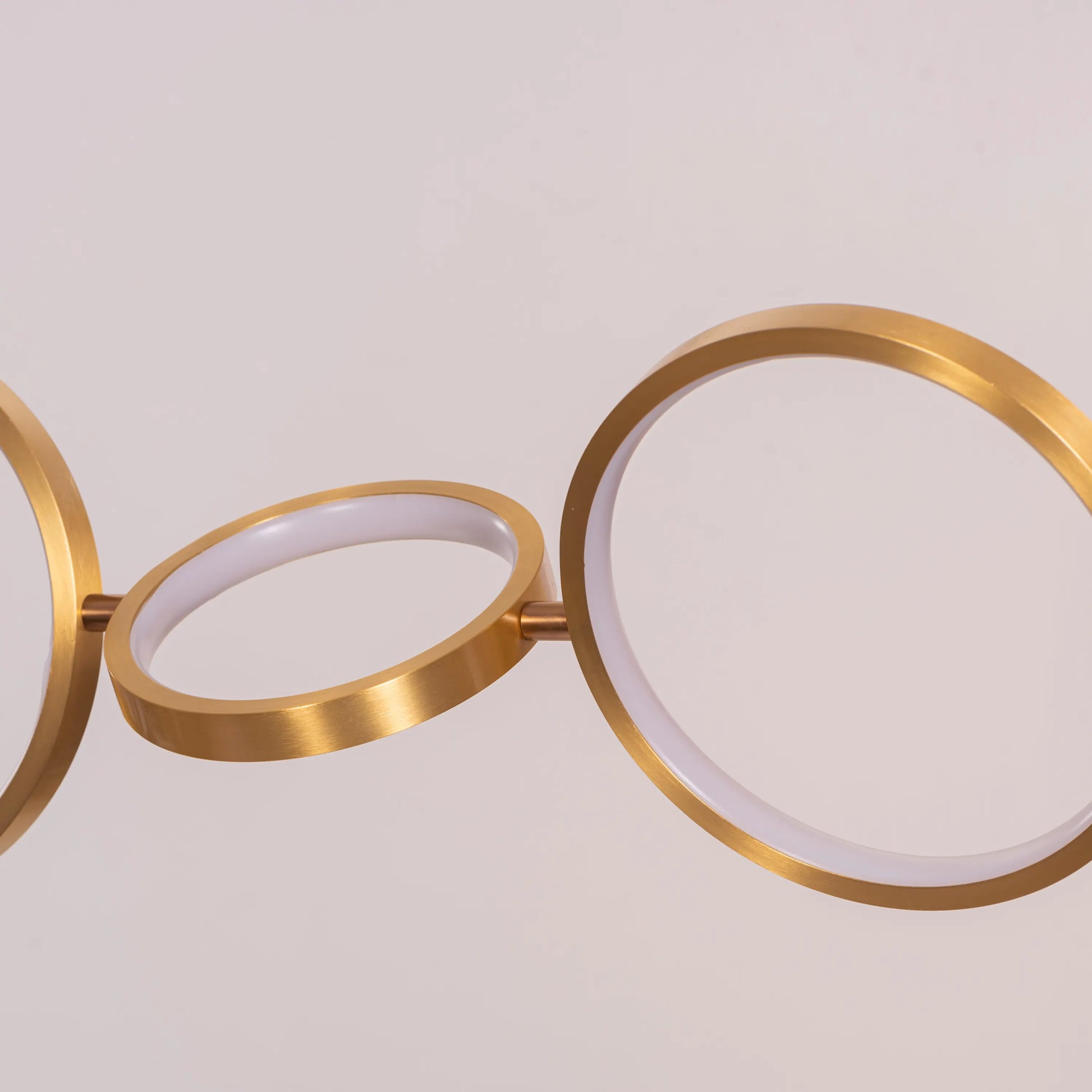 Large gold How We Play chandelier with playful design elements illuminating a luxurious living room