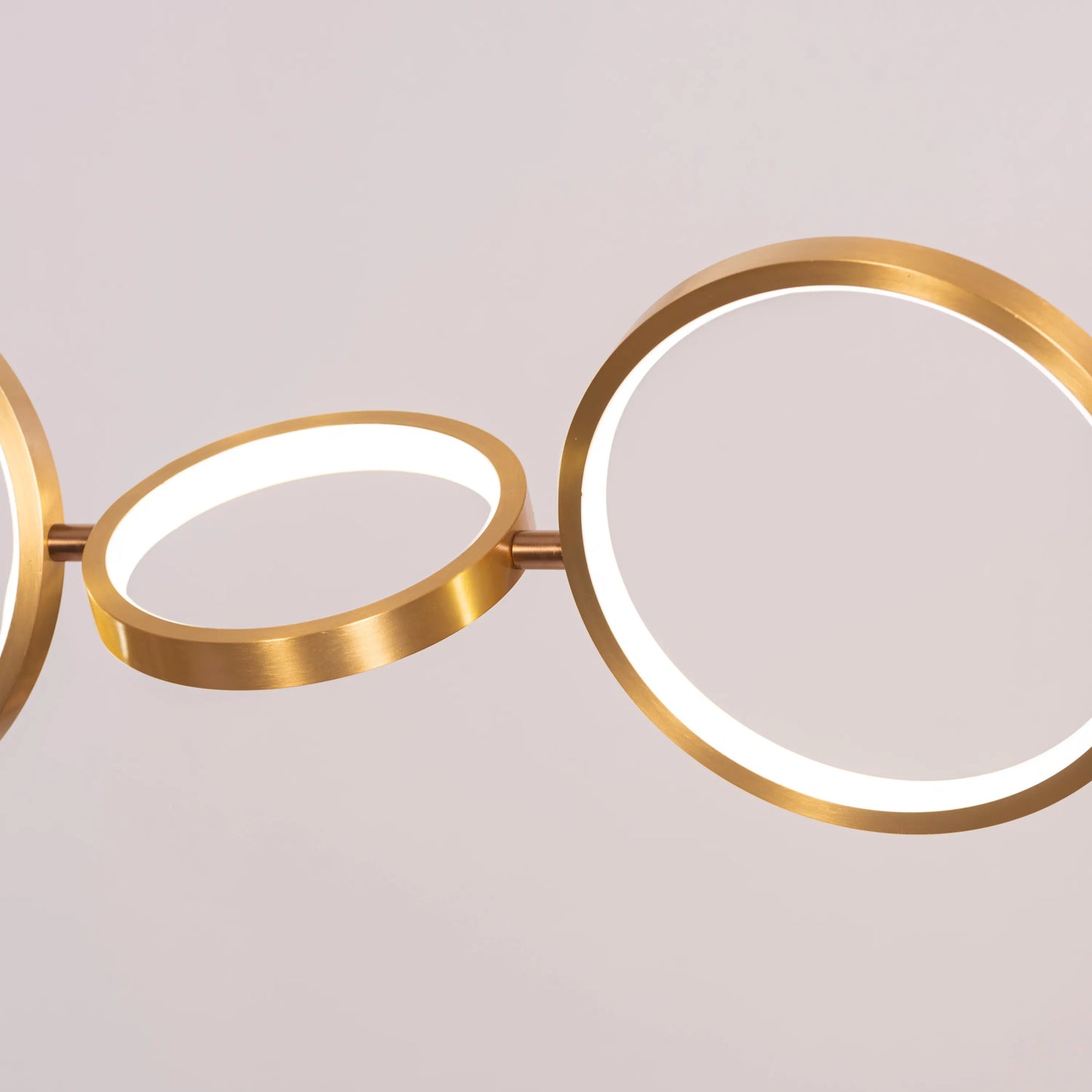 Large gold How We Play chandelier with playful design elements illuminating a luxurious living room