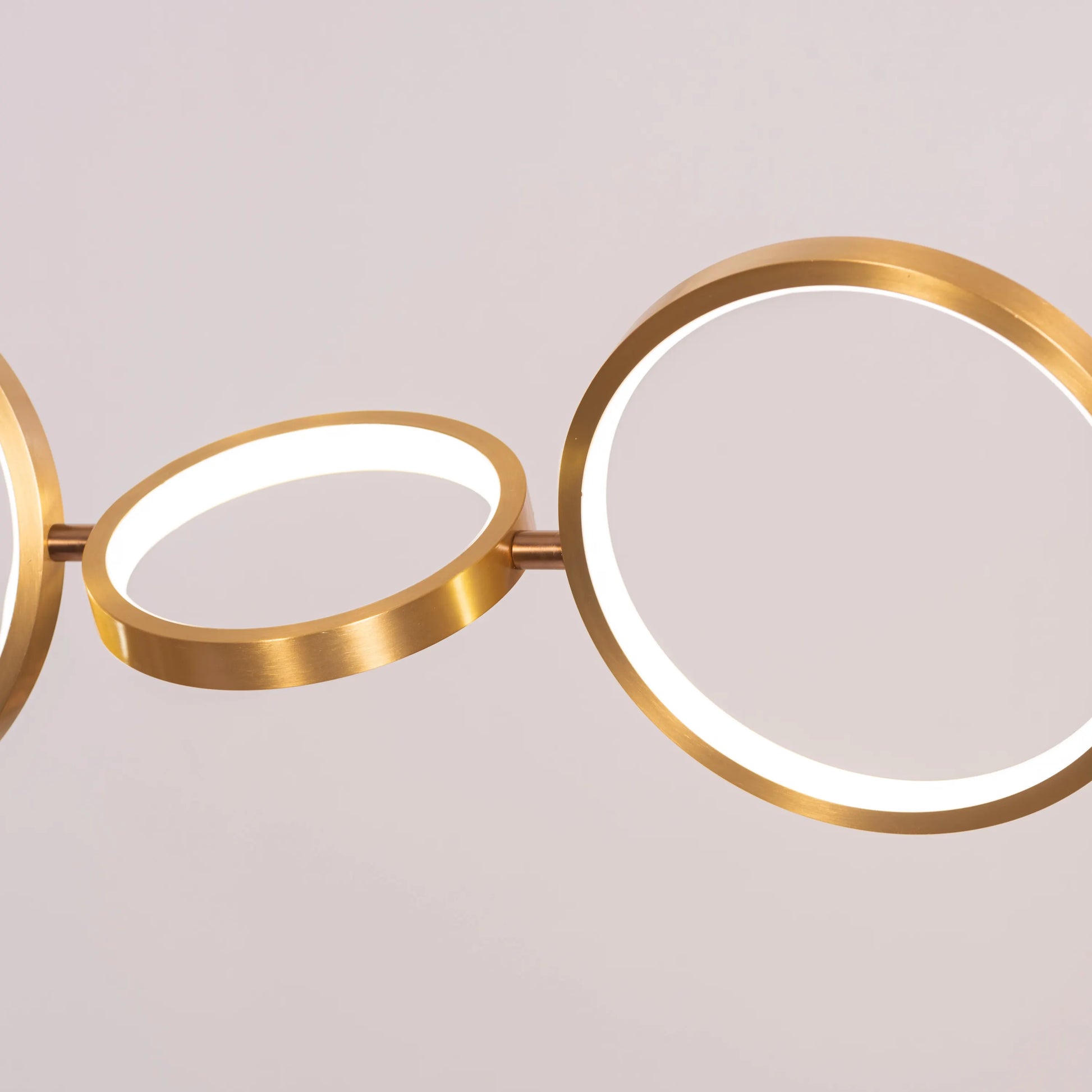 Large gold How We Play chandelier with playful design elements illuminating a luxurious living room