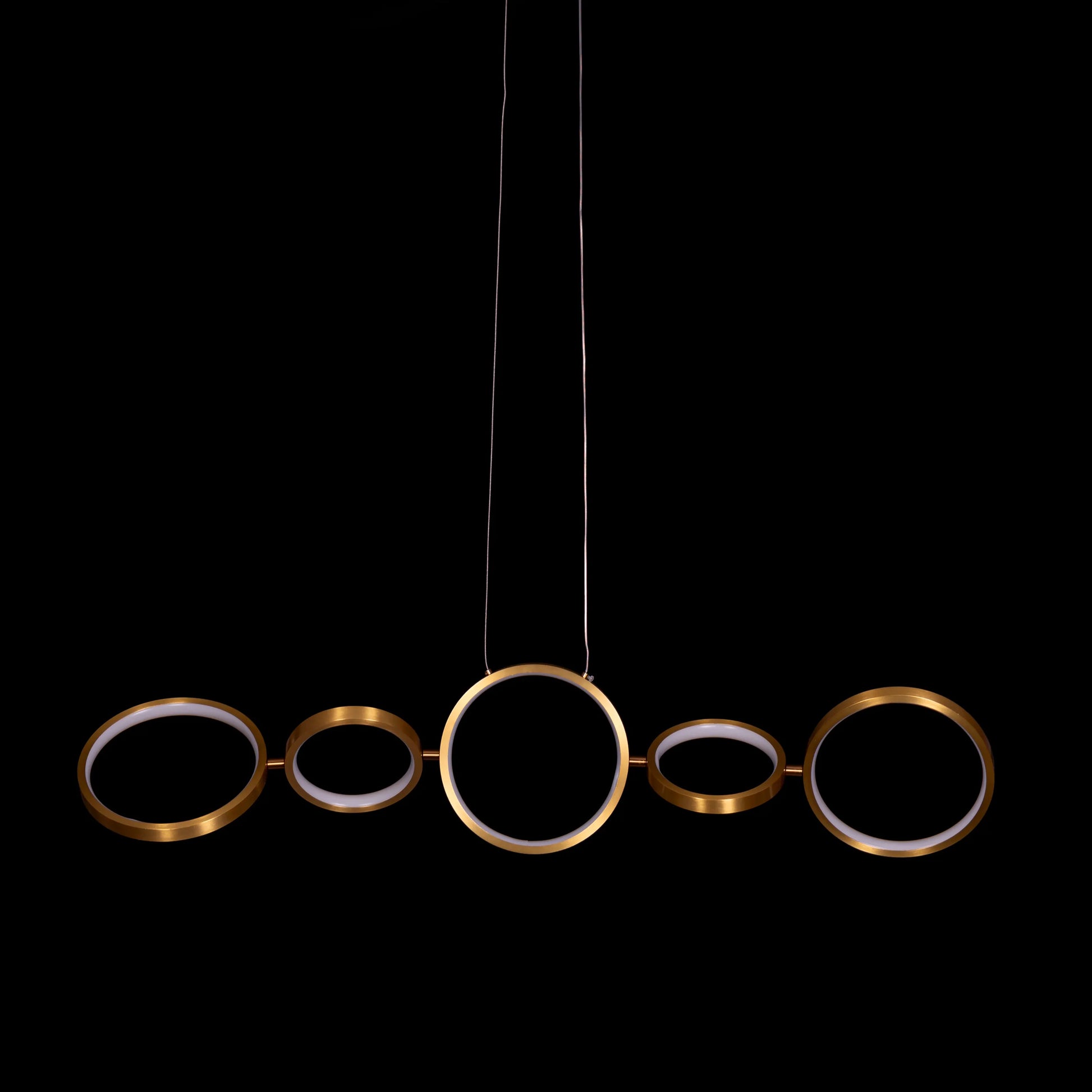 Large gold How We Play chandelier with playful design elements illuminating a luxurious living room