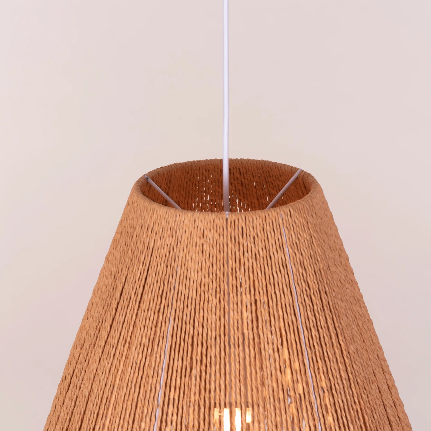 A charming rattan pendant light named 'Say What You Mean,' featuring a woven rattan shade with a bold, open design. The natural fibers create an inviting atmosphere as light filters through, casting playful shadows. This pendant combines bohemian style with a contemporary touch, making it a perfect addition to any space seeking warmth and character.
