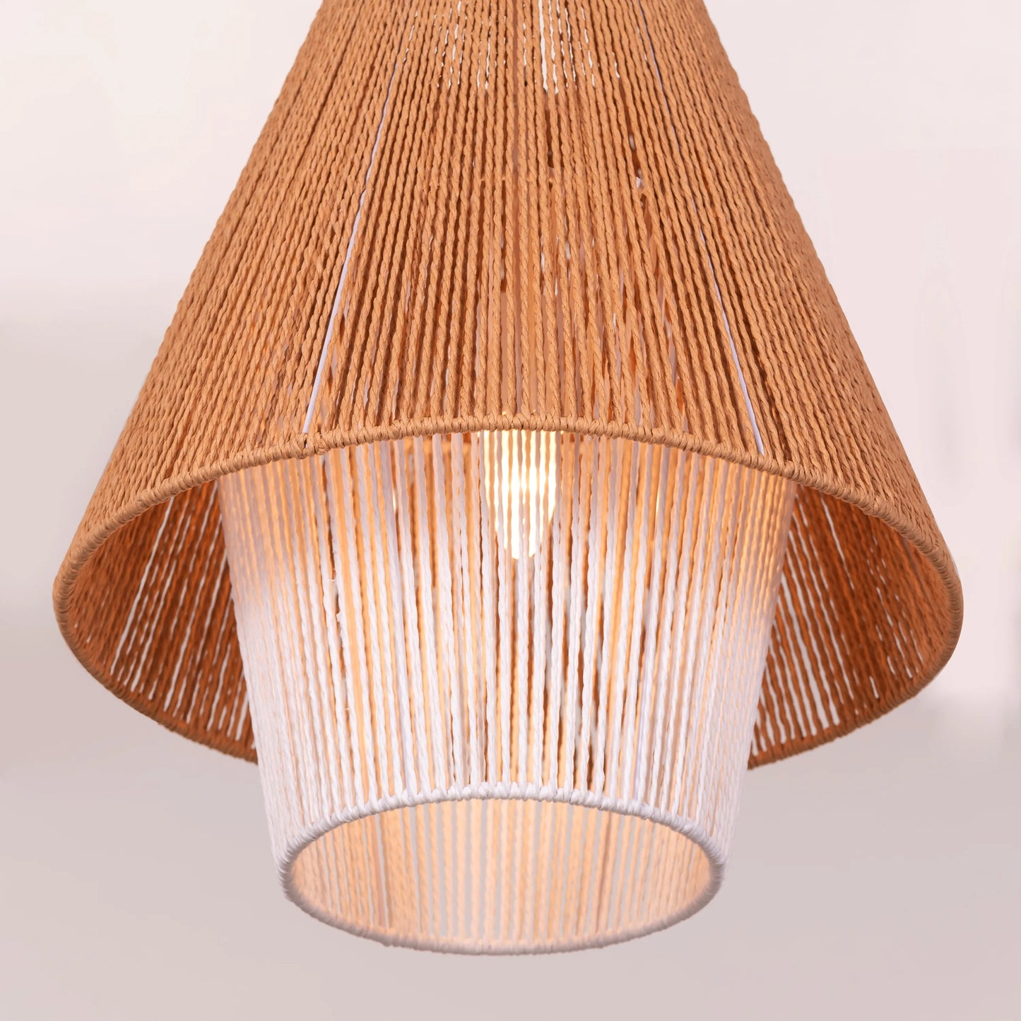 A charming rattan pendant light named 'Say What You Mean,' featuring a woven rattan shade with a bold, open design. The natural fibers create an inviting atmosphere as light filters through, casting playful shadows. This pendant combines bohemian style with a contemporary touch, making it a perfect addition to any space seeking warmth and character.