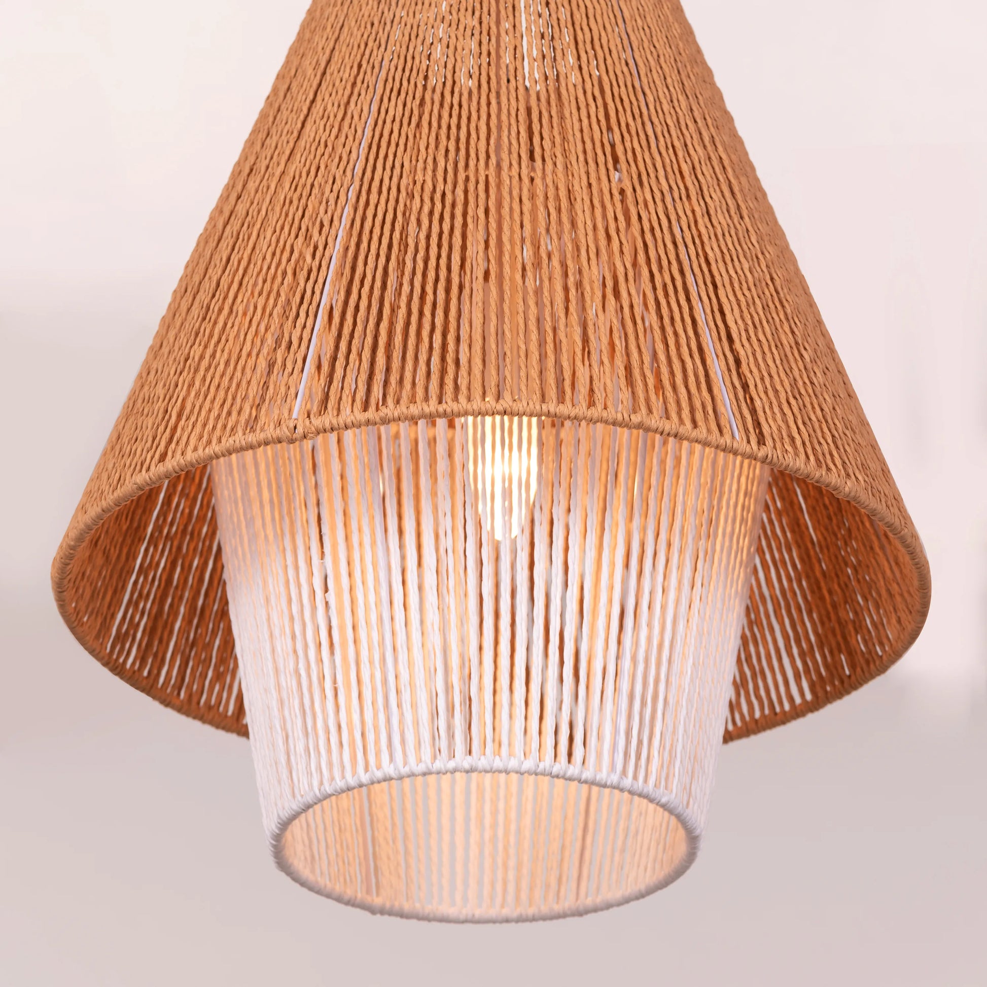 A charming rattan pendant light named 'Say What You Mean,' featuring a woven rattan shade with a bold, open design. The natural fibers create an inviting atmosphere as light filters through, casting playful shadows. This pendant combines bohemian style with a contemporary touch, making it a perfect addition to any space seeking warmth and character.