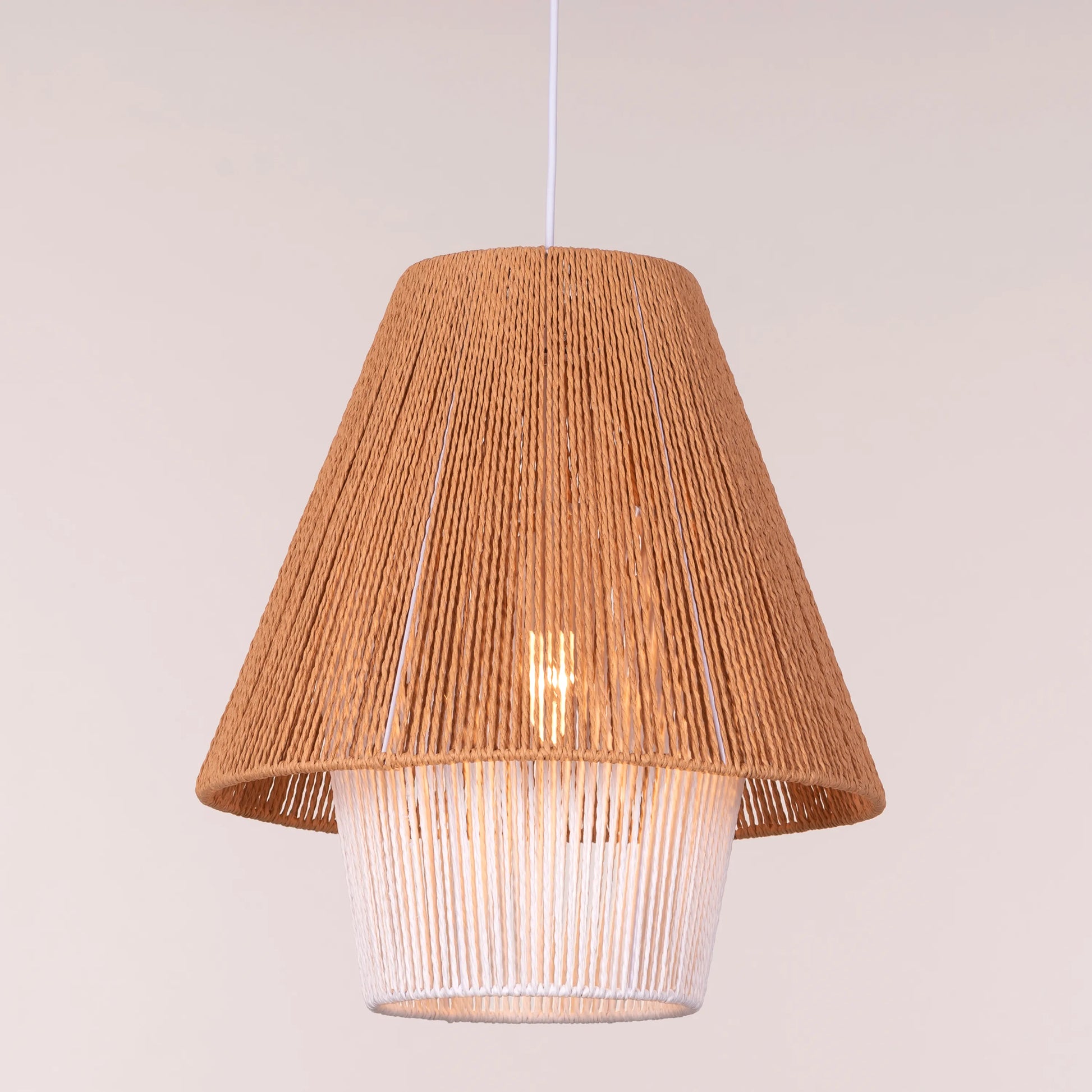 A charming rattan pendant light named 'Say What You Mean,' featuring a woven rattan shade with a bold, open design. The natural fibers create an inviting atmosphere as light filters through, casting playful shadows. This pendant combines bohemian style with a contemporary touch, making it a perfect addition to any space seeking warmth and character.