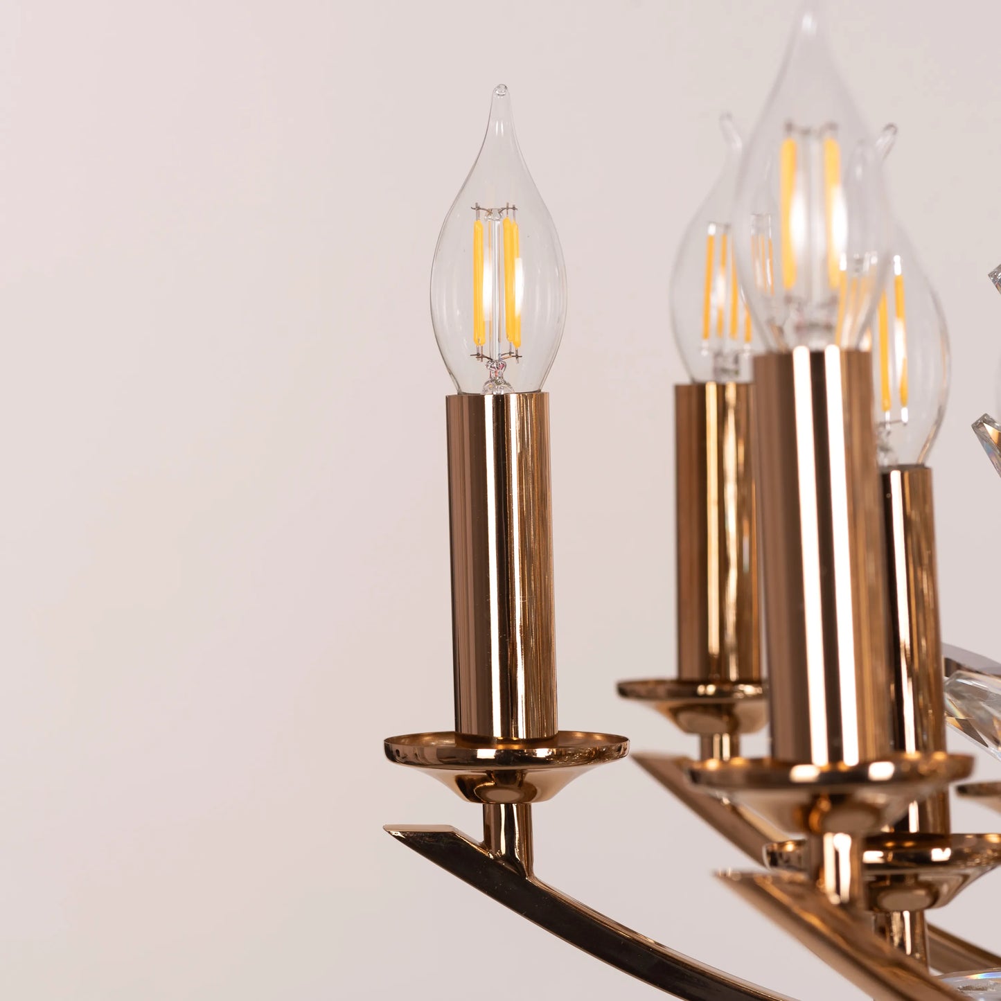 Jewel Of My Heart gold and crystal chandelier illuminating a luxurious master bedroom with its warm, romantic glow