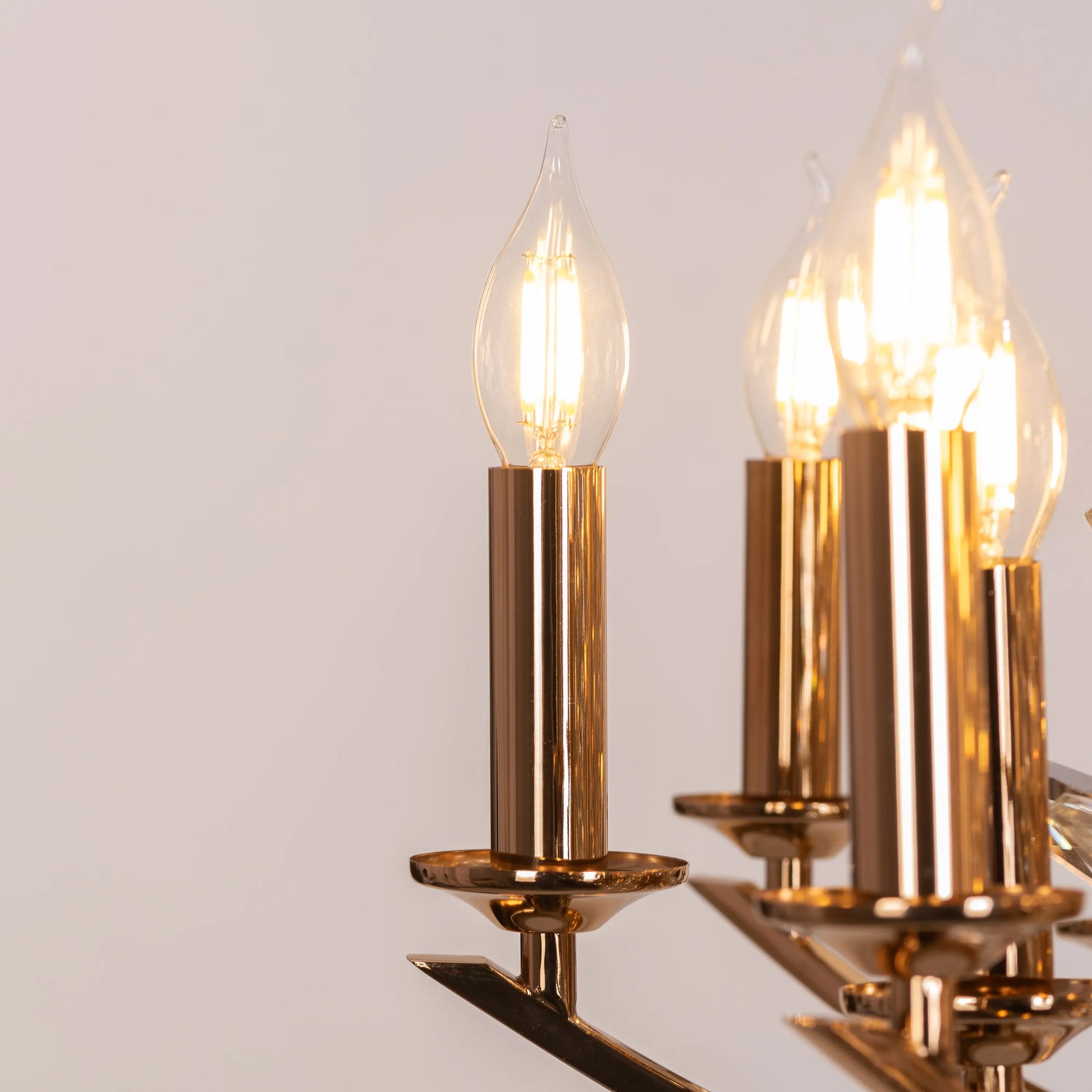 Jewel Of My Heart gold and crystal chandelier illuminating a luxurious master bedroom with its warm, romantic glow