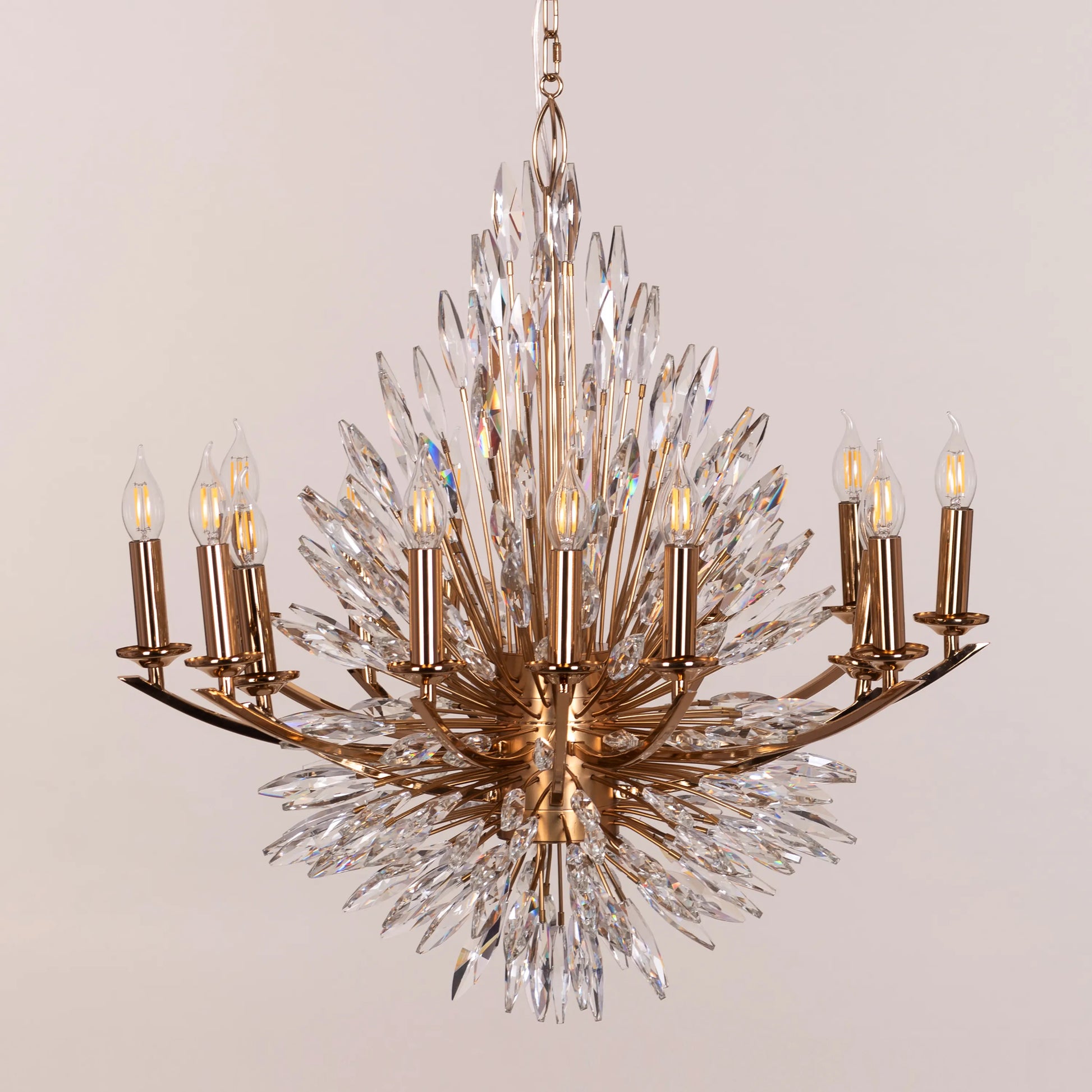 Jewel Of My Heart gold and crystal chandelier illuminating a luxurious master bedroom with its warm, romantic glow