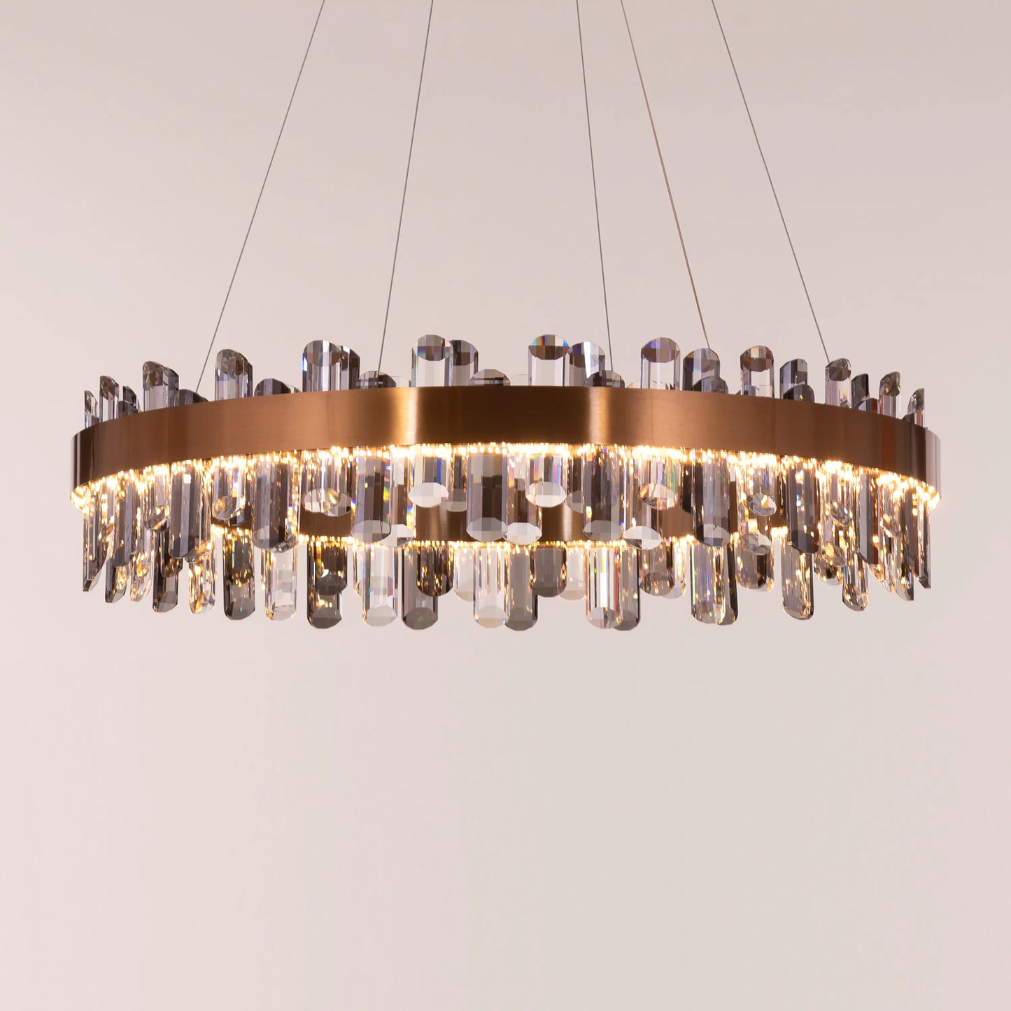 Large gold Start From Scratch round crystal chandelier illuminating a luxurious living room