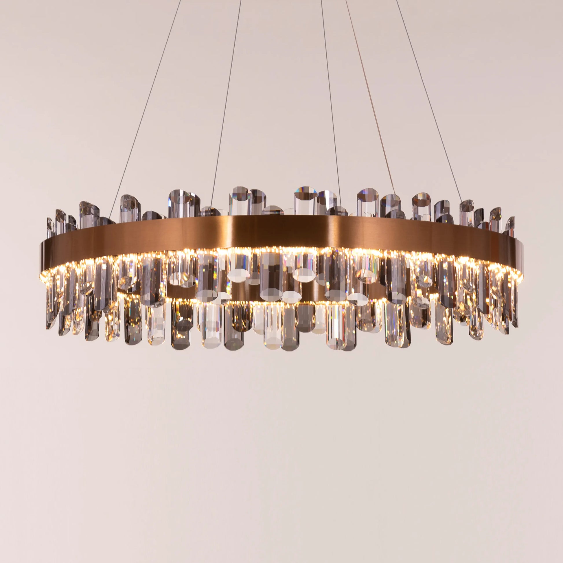 Large gold Start From Scratch round crystal chandelier illuminating a luxurious living room