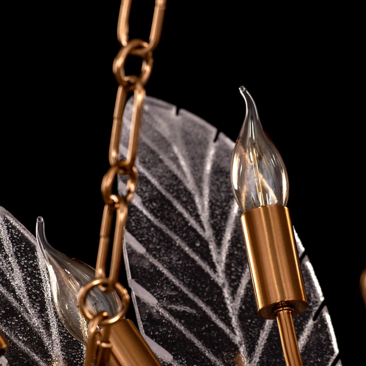 Trance Glass Chandelier suspended in a grand foyer, its gold framework and glass elements creating a dazzling display.