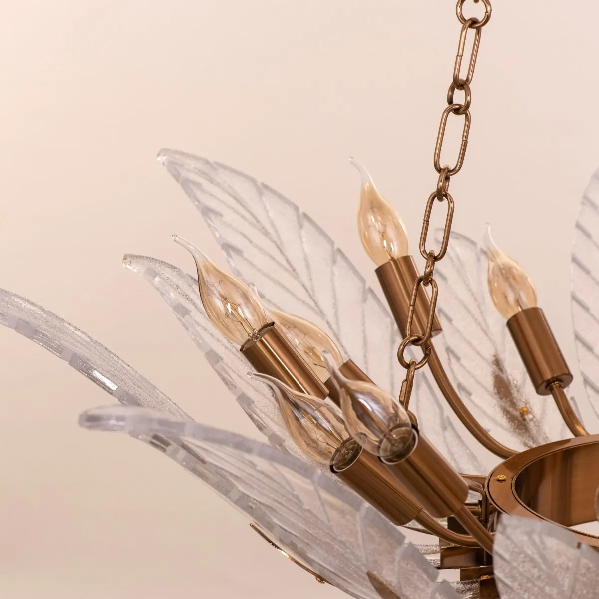 Trance Glass Chandelier suspended in a grand foyer, its gold framework and glass elements creating a dazzling display.