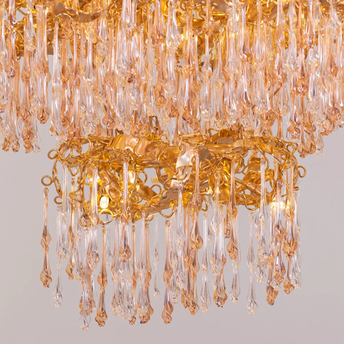 Medium-sized amber crystal chandelier with two layers resembling a golden galaxy
