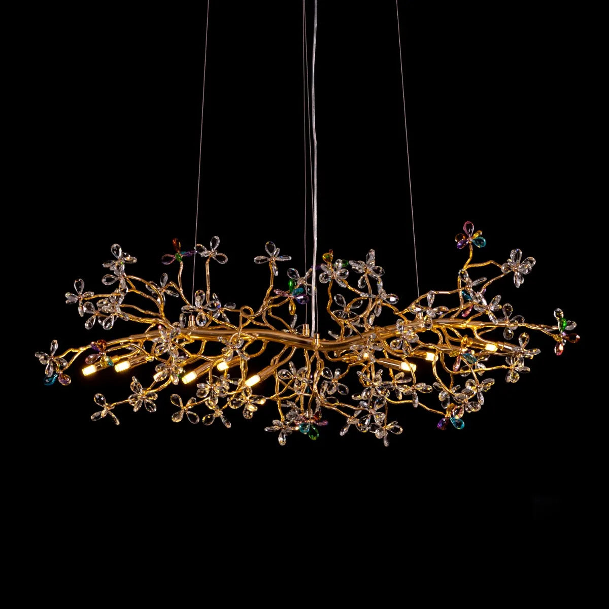 Elegant Daylight Fades Tree Branch Crystal Chandelier illuminating a modern dining room.