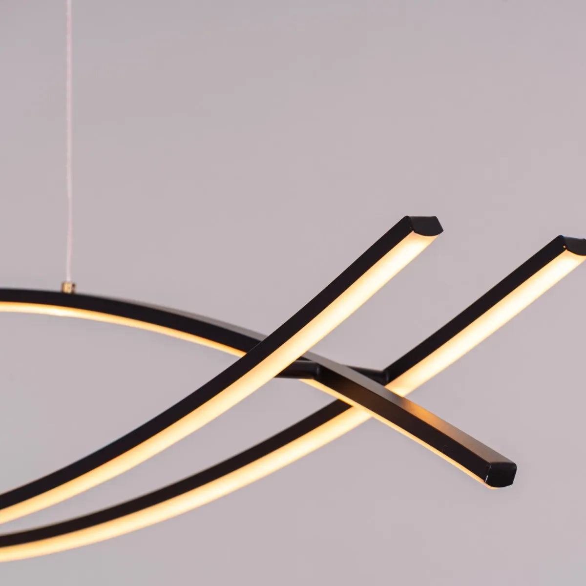 Believe In Me Chandelier suspended in a home office, its striking black elements contrasting with warm white light, creating an inspiring workspace.