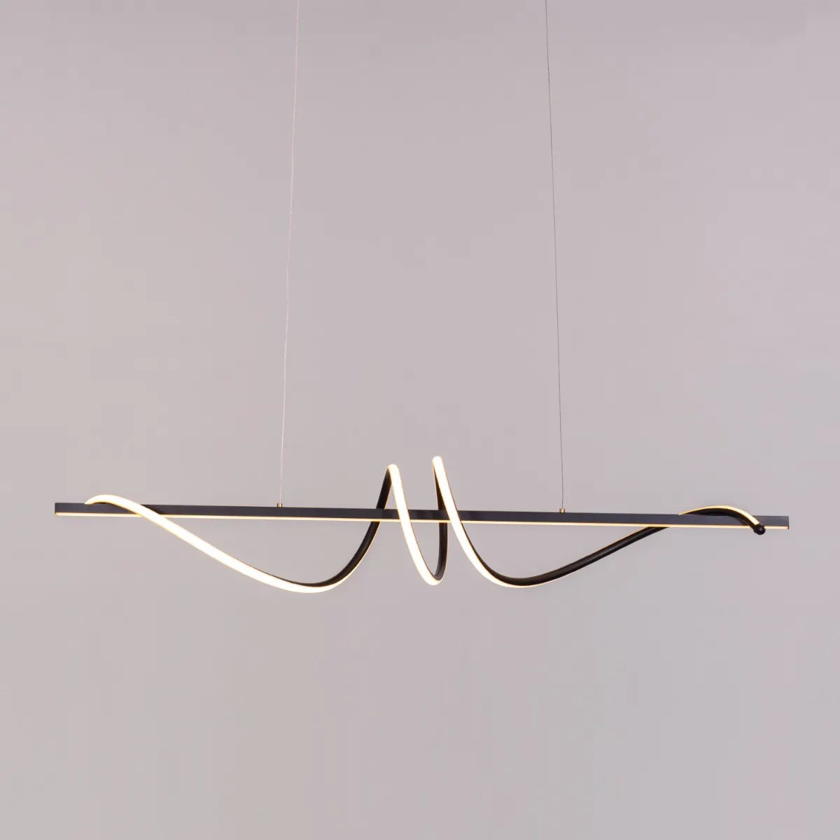 Up In The Air Chandelier suspended in a modern living room, its black elements contrasting dramatically with warm white light.