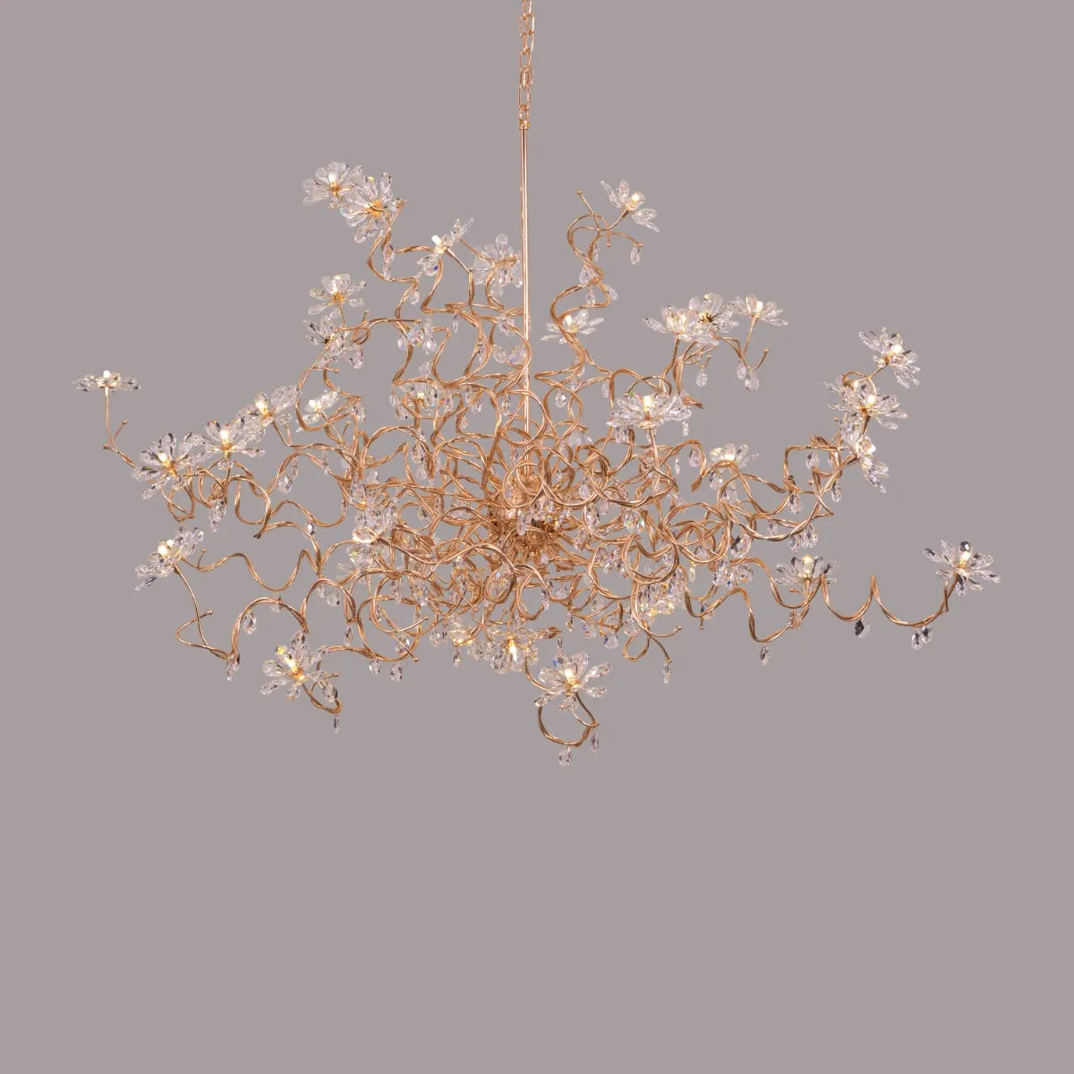 Large gold crystal chandelier with multiple tiers of cascading crystals