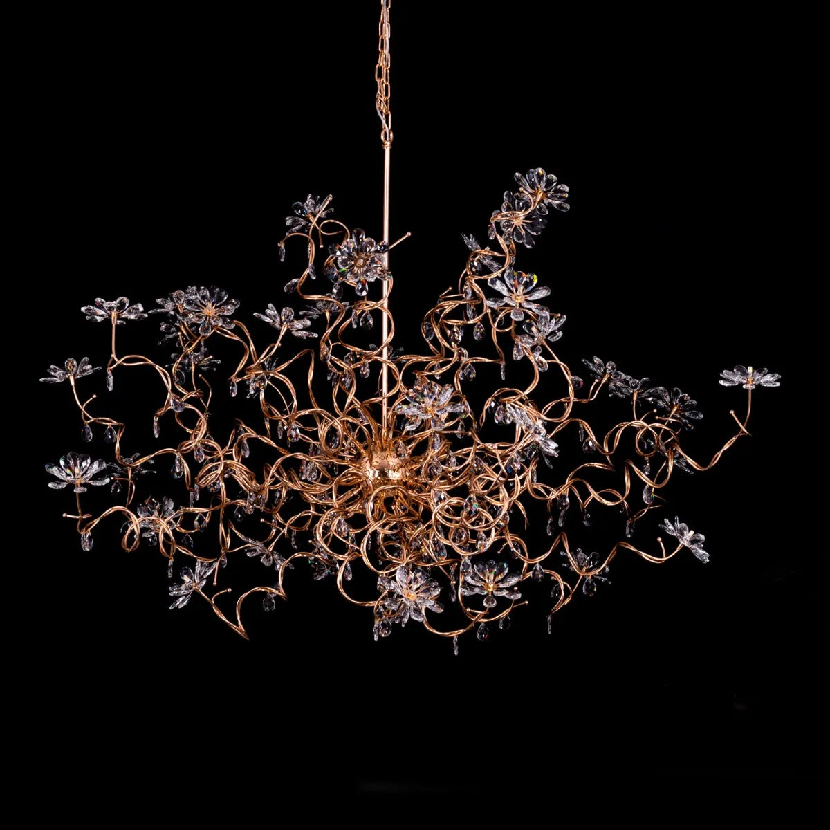 Large gold crystal chandelier with multiple tiers of cascading crystals