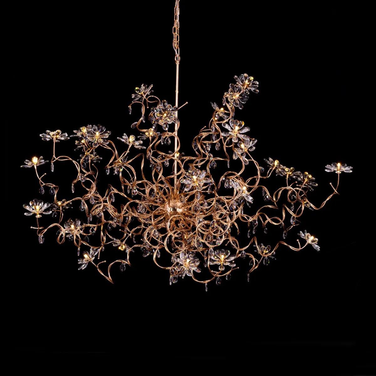 Large gold crystal chandelier with multiple tiers of cascading crystals