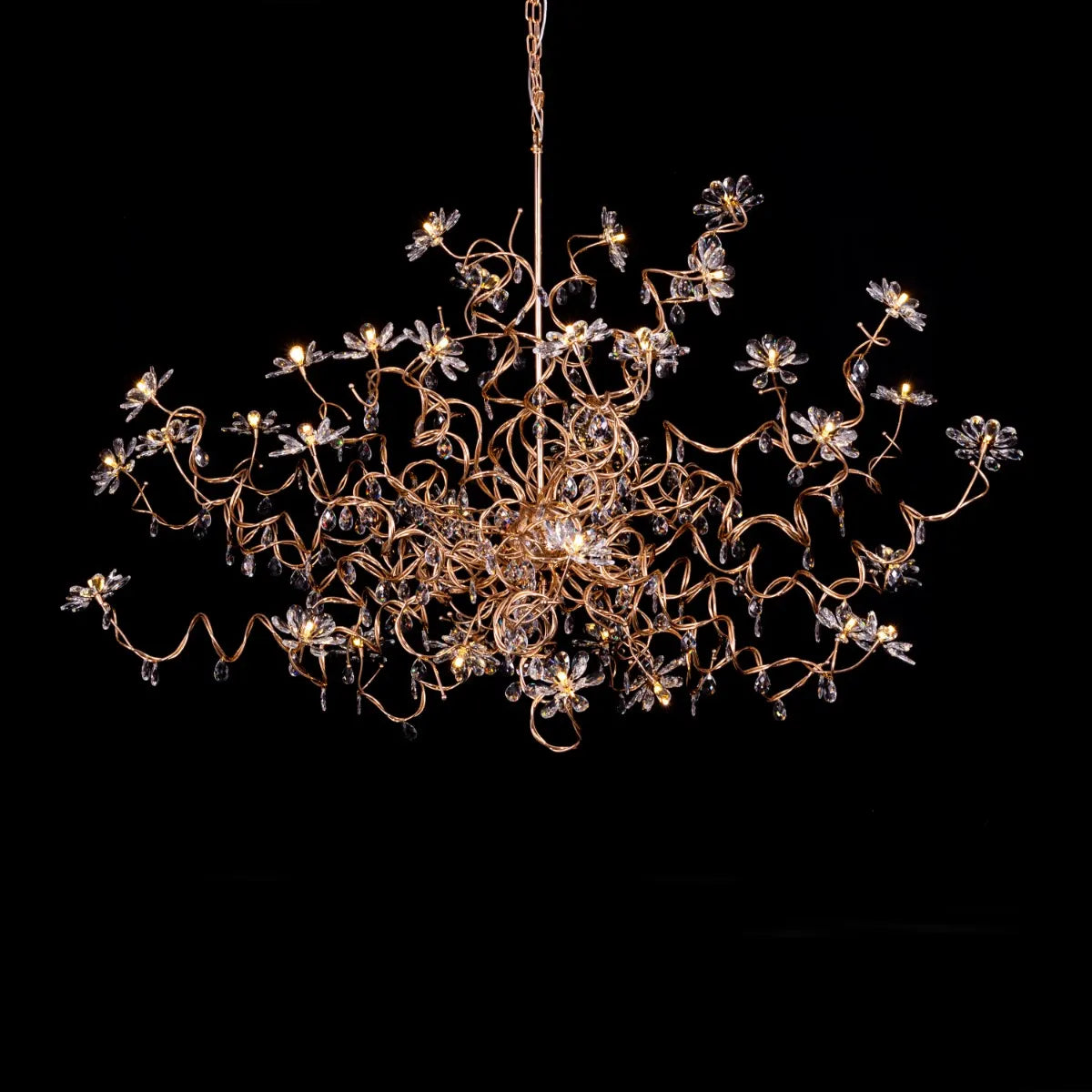 Large gold crystal chandelier with multiple tiers of cascading crystals