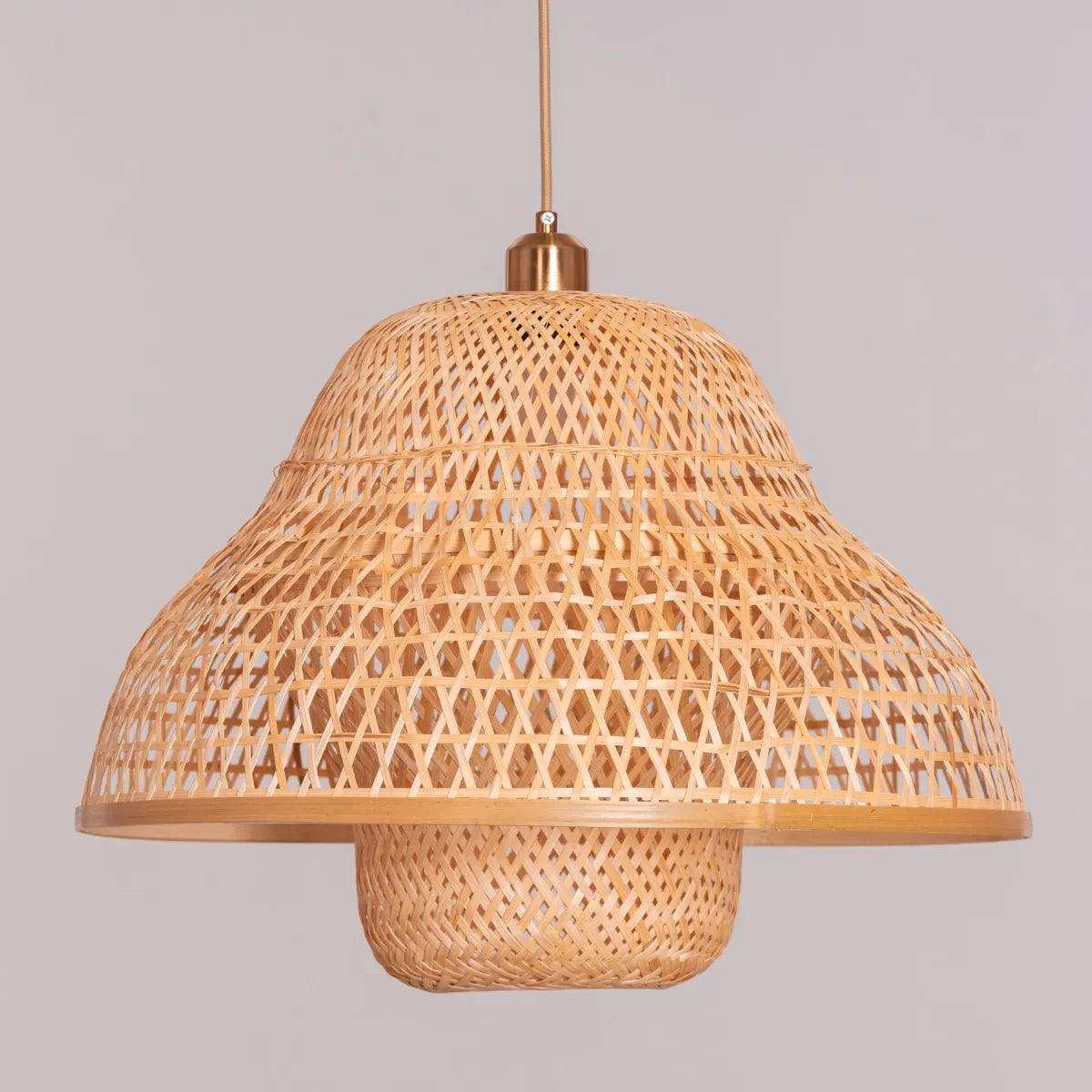 A stylish rattan pendant light named 'Paid The Bill,' featuring a handwoven, spherical rattan shade with intricate patterns. The natural fibers allow light to softly filter through, casting warm, textured shadows. This pendant light blends bohemian charm with modern design, adding a cozy and artistic touch to any room.
