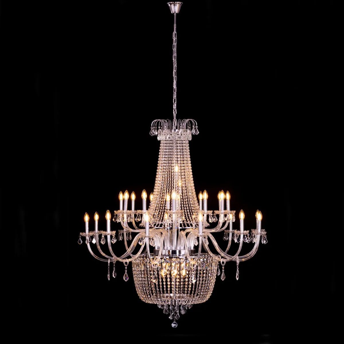 Large chrome crystal chandelier with letter-shaped elements, hanging in a luxurious living room