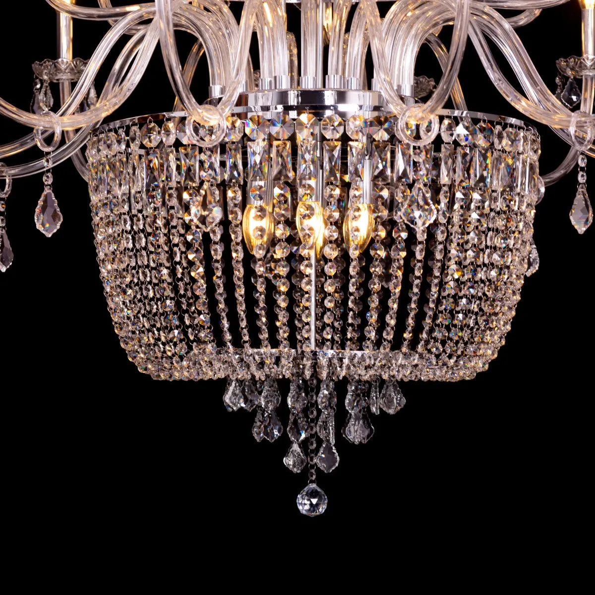 Large chrome crystal chandelier with letter-shaped elements, hanging in a luxurious living room