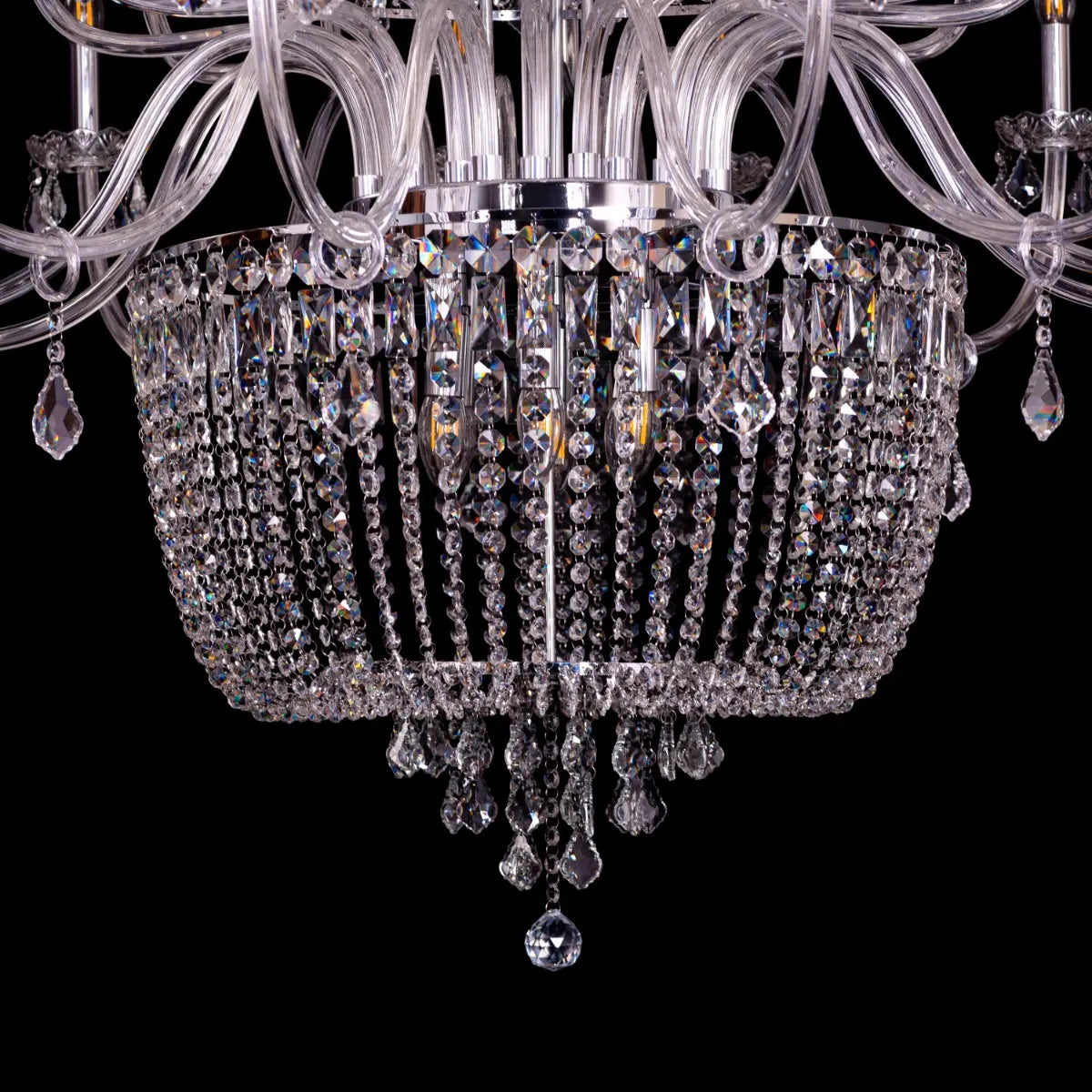 Large chrome crystal chandelier with letter-shaped elements, hanging in a luxurious living room