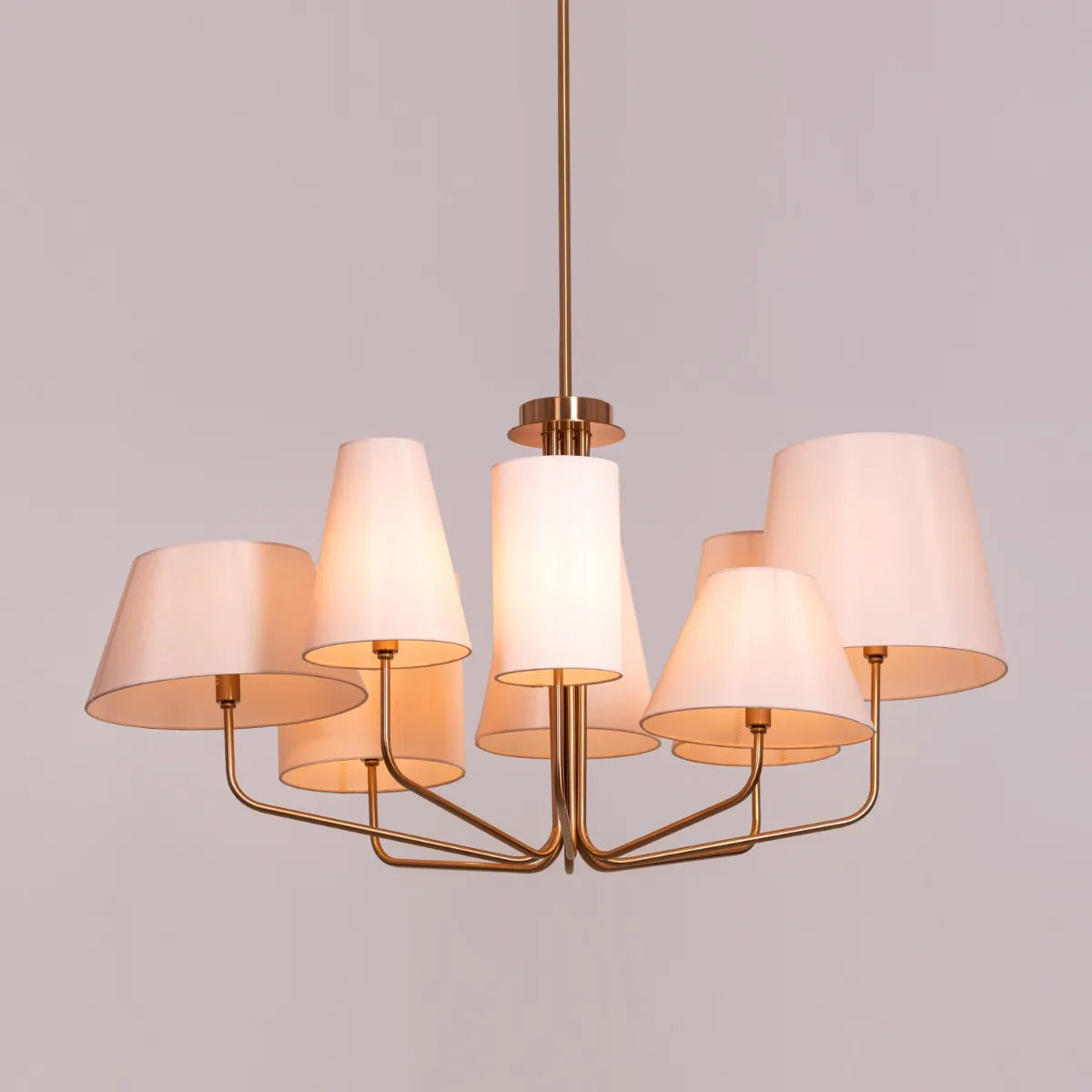 Large gold and beige fabric chandelier with layered shades resembling fluttering pages