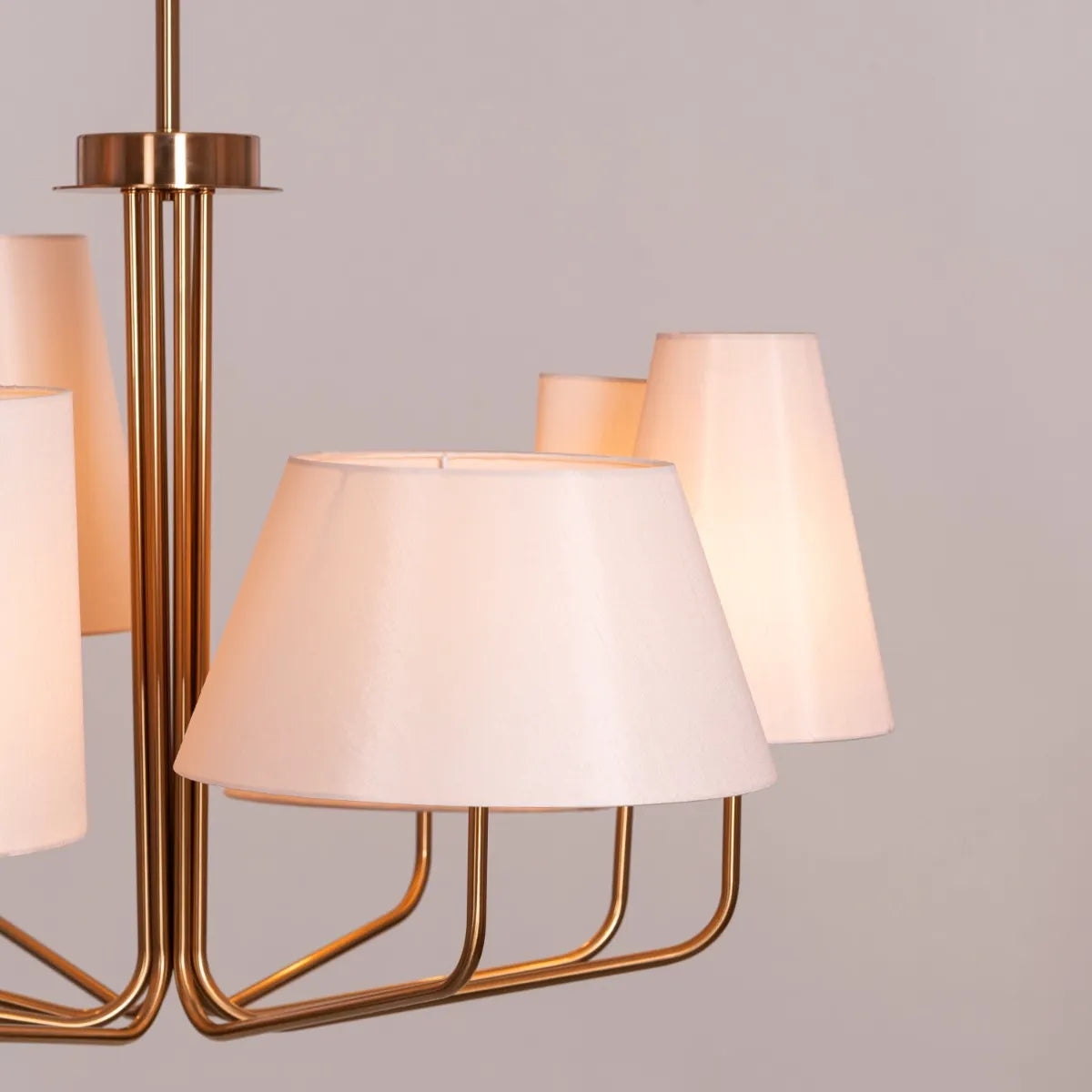 Large gold and beige fabric chandelier with layered shades resembling fluttering pages