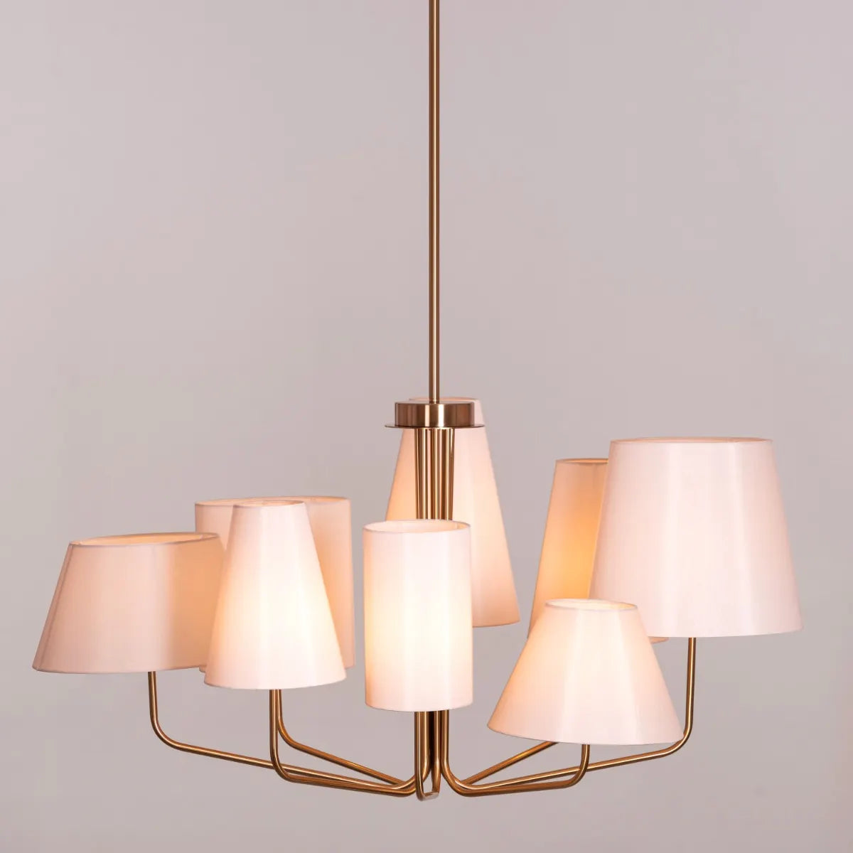 Large gold and beige fabric chandelier with layered shades resembling fluttering pages