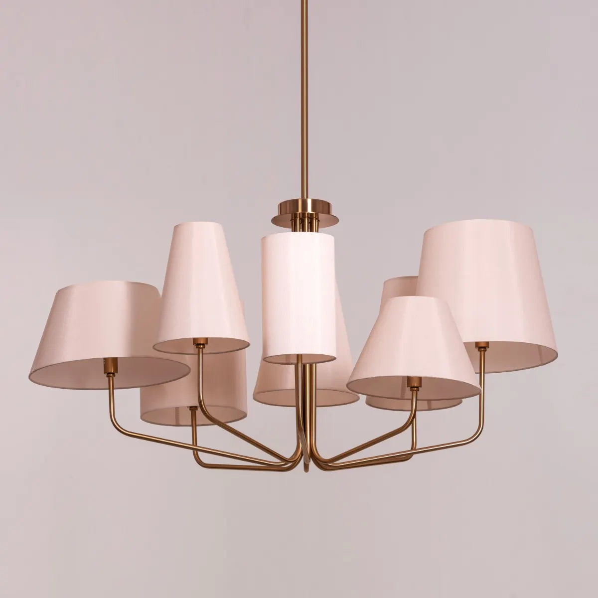Large gold and beige fabric chandelier with layered shades resembling fluttering pages
