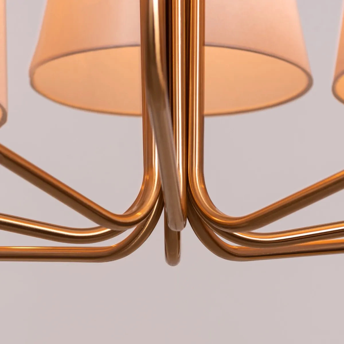 Large gold and beige fabric chandelier with layered shades resembling fluttering pages