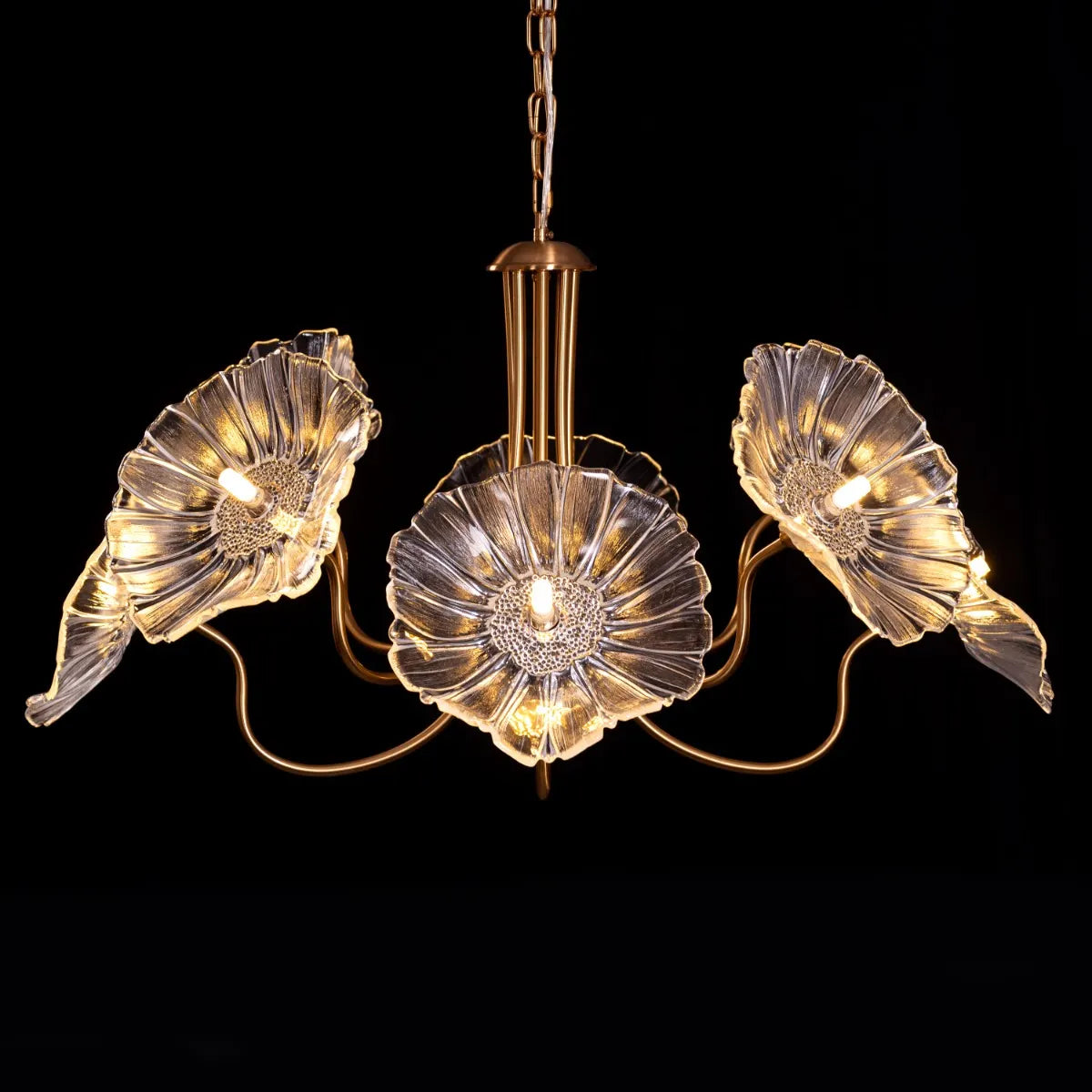 Late For Reality large gold chandelier with glass elements.