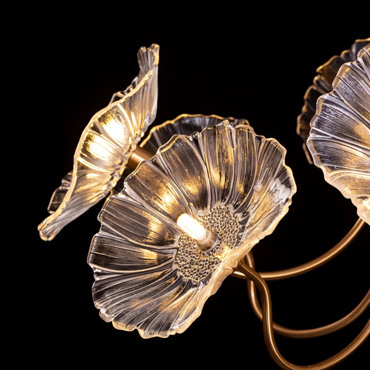 Late For Reality large gold chandelier with glass elements.